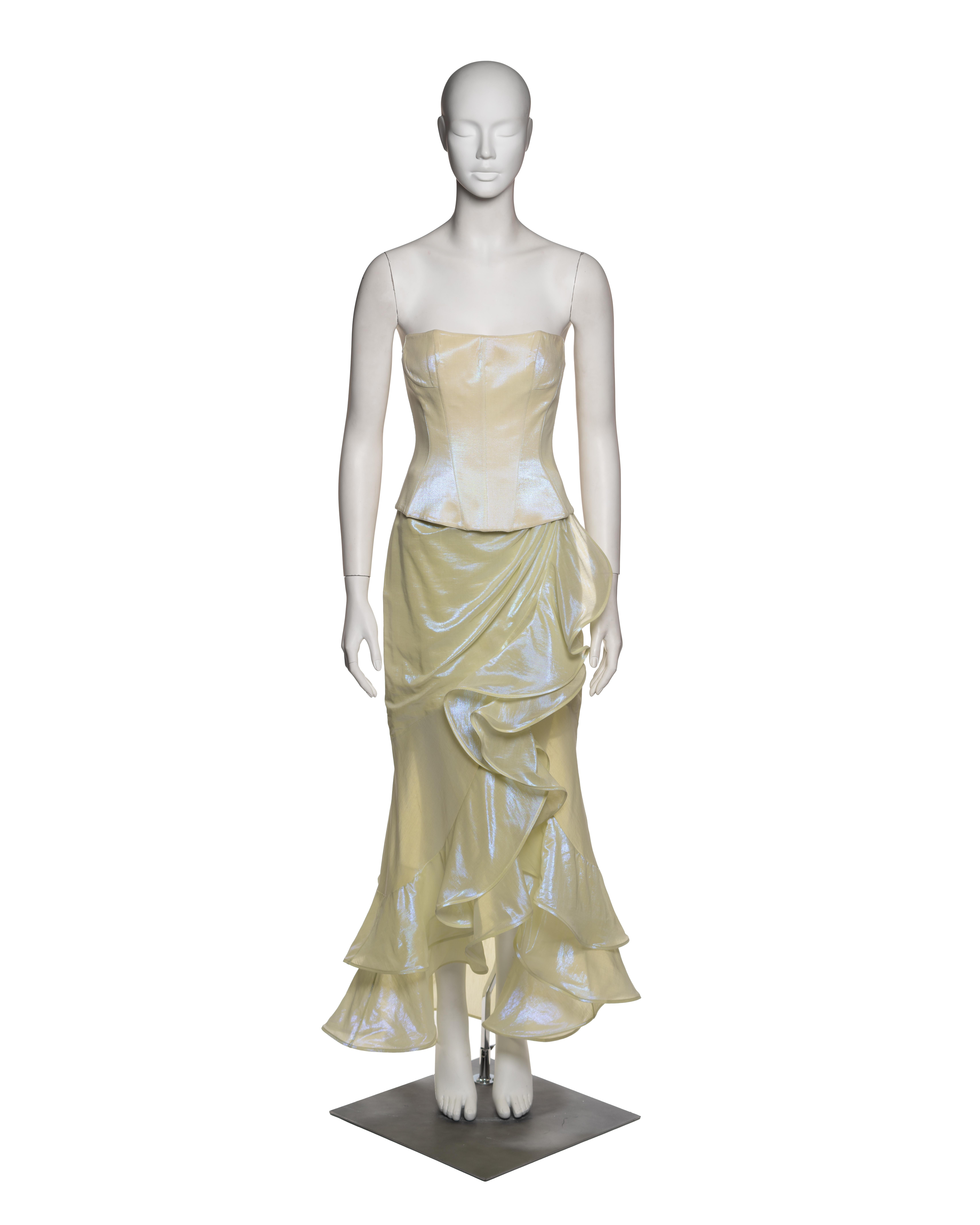 A two-piece ensemble from Thierry Mugler’s Spring-Summer 1999 collection, constructed in an pearlescent chartreuse synthetic organza with an iridescent finish. The corset-style top is structured with internal boning and precise darting, sculpting