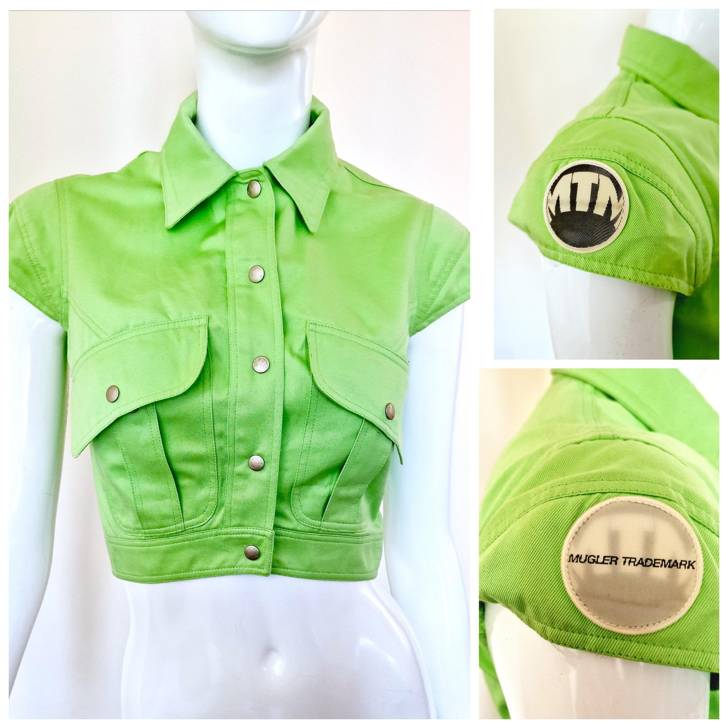 Crop top by Thirry Mugler!
MTM / Mugler Trademark light reflection patch on the sleeve. --> MTM logo / Mugler Trademark
2 front pockets.
*MTM*  buttons!

EXCELLENT condition!

SIZE
Fits from XS to small.
Marked size: FR36.
Length: 40 cm / 15.7