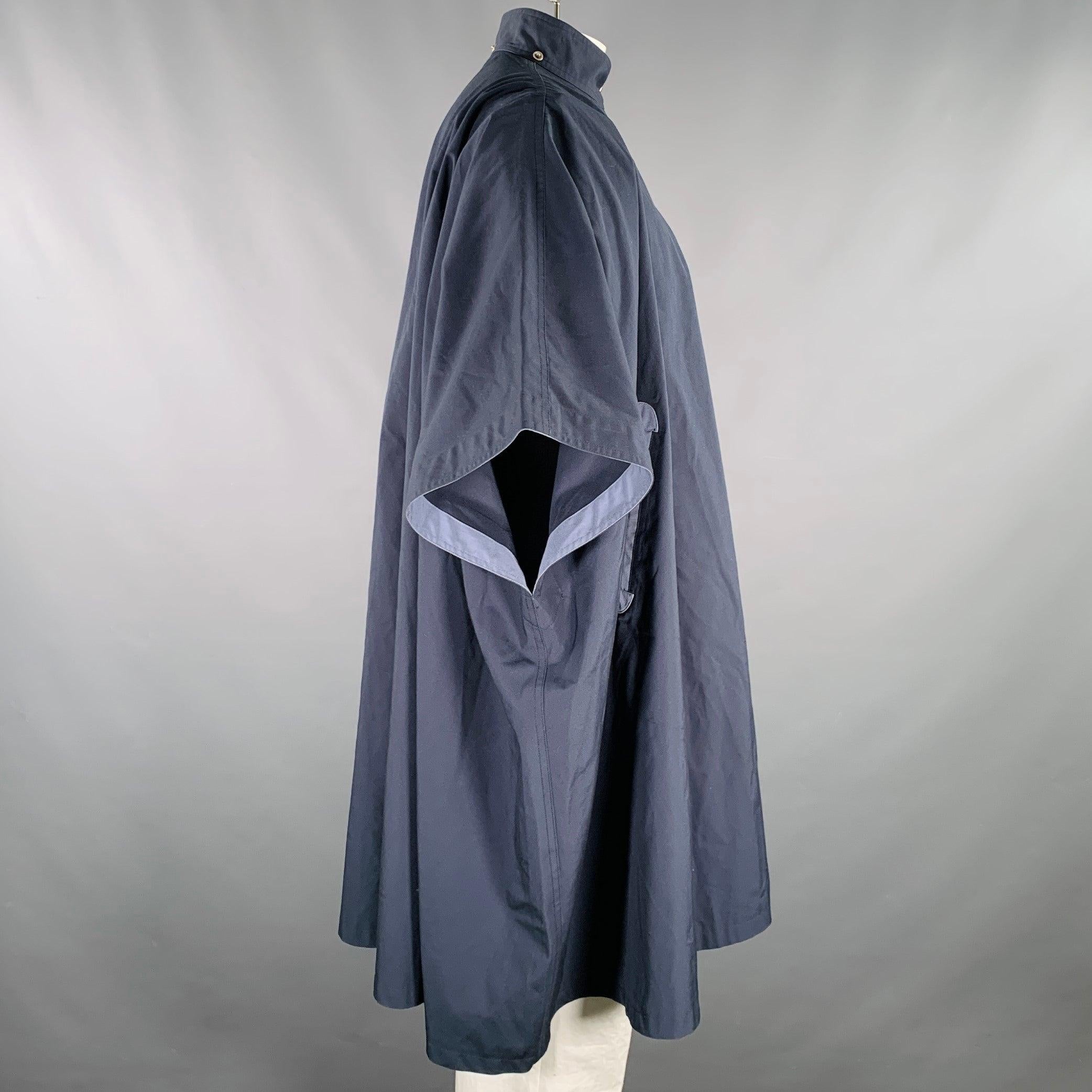 Vintage THIERRY MUGLER coat
in a navy cotton blend fabric featuring a poncho style, light blue trim details, and hidden snap closure with belted neck detail.Excellent Pre-Owned Condition. 

Marked:   size not marked 

Measurements: 
 
Shoulder: 20