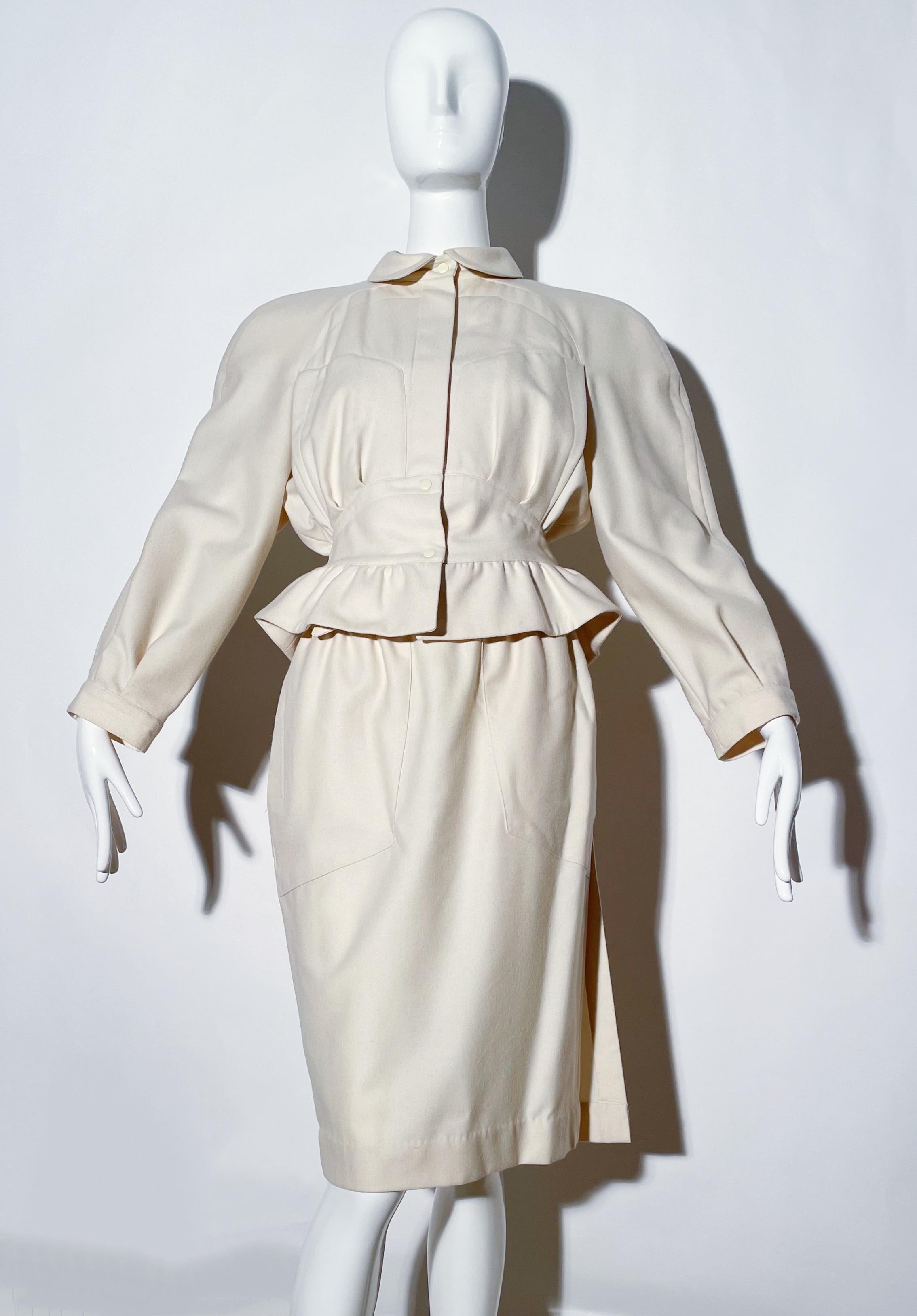 Creme peplum skirt suit. Collared. Shoulder pads. Front snap closures on blazer. Skirt is wrap style. 
*Condition: Great vintage condition. Chipped paint on belt loops. 

Measurements Taken Laying Flat (inches)—
Shoulder to Shoulder: 17 in.
Sleeve