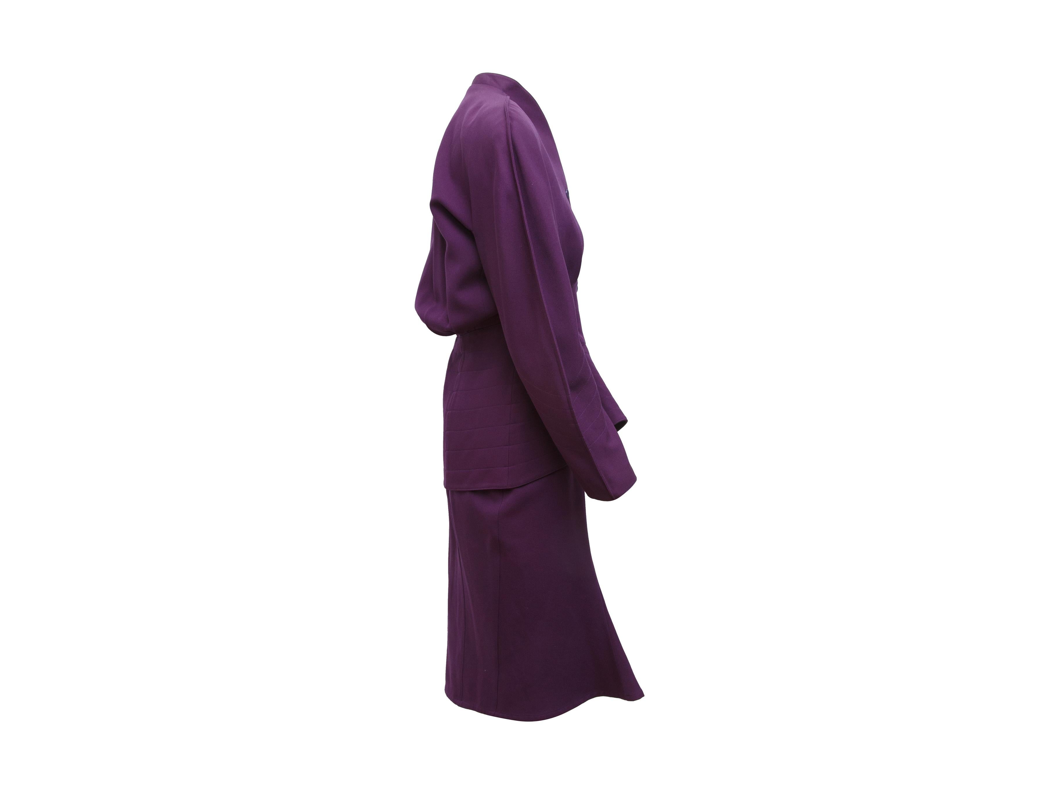 Product details:  Vintage purple wool skirt suit set by Thierry Mugler.  Circa the 1980s.  Stand collar.  Long sleeves.  Button-front closure.  Banded waist.  Matching pencil skirt.  Concealed hook and zip fly closure.  Label size FR 42.  Jacket: 