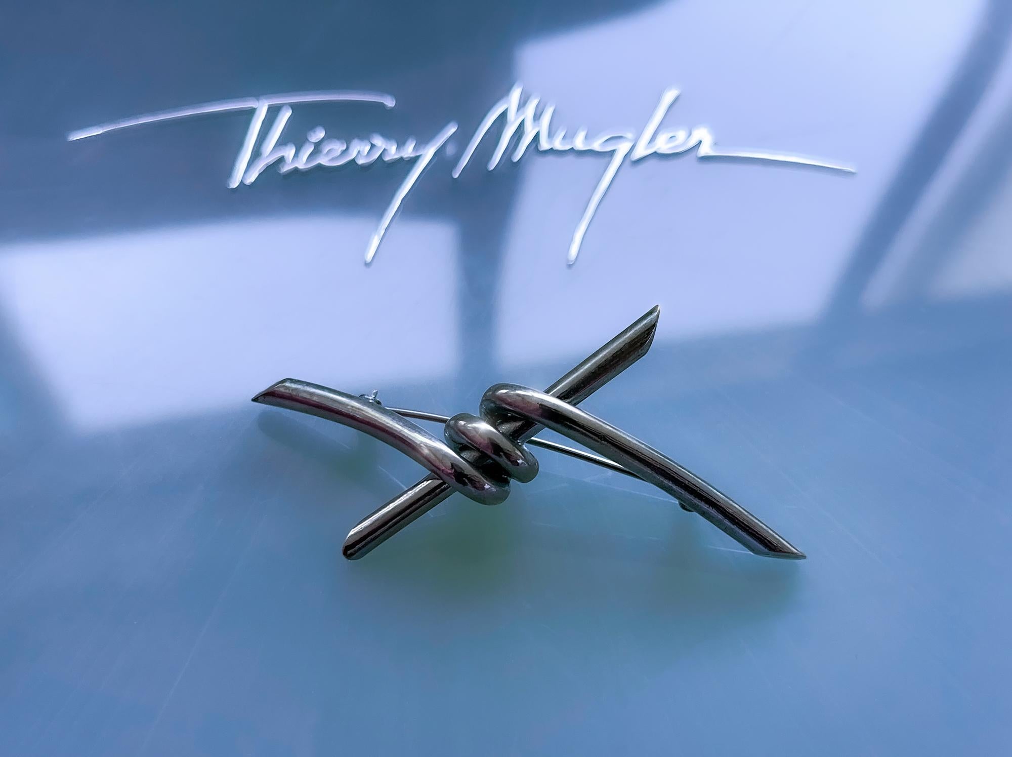 Thierry Mugler silver tone metal barbed wire brooch.

Thierry Mugler’s creations have always stood as iconic statements of bold innovation and avant-garde design. The extremely rare archival barbed wire brooch is a striking example of his