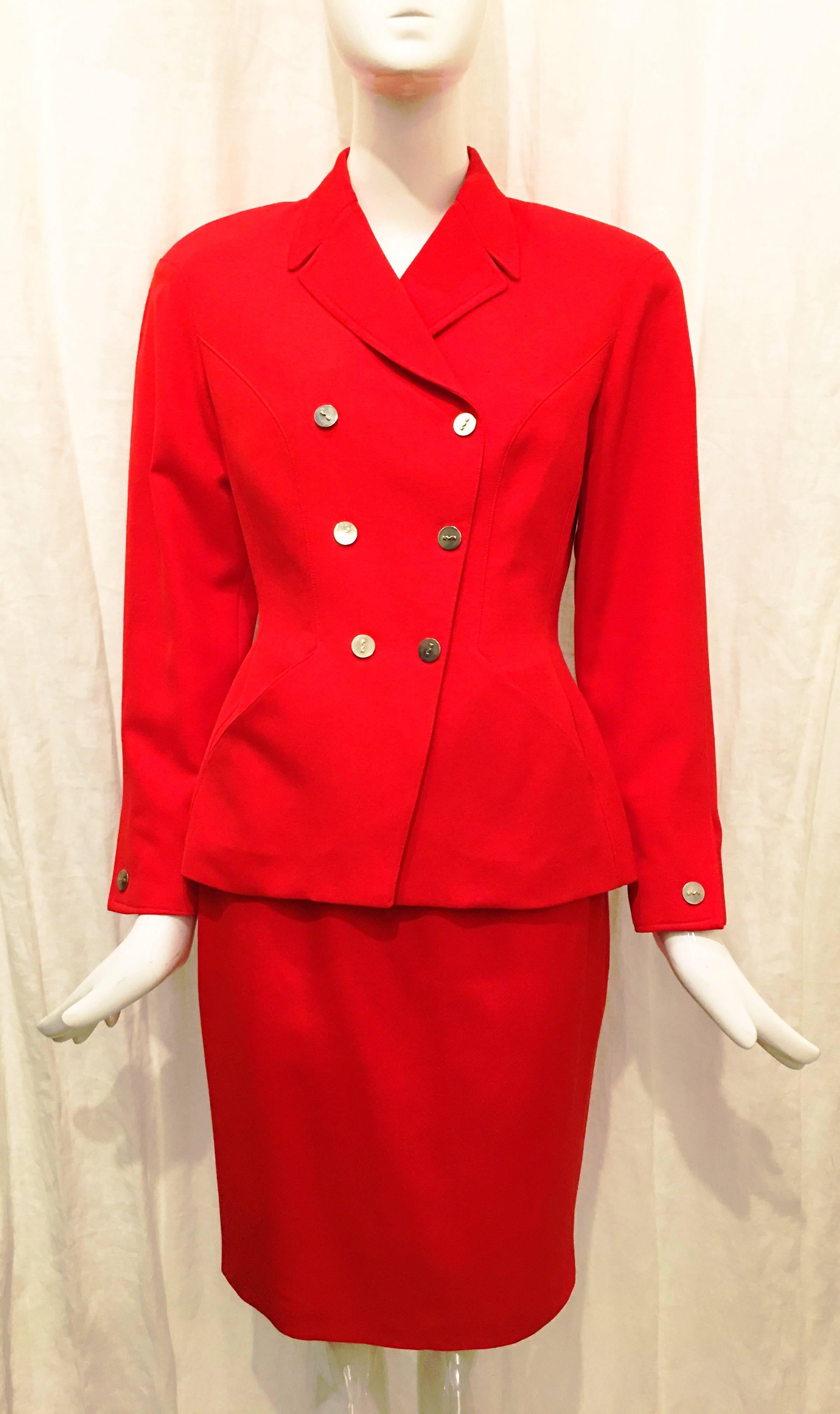 Red double breasted suit jacket with six silver Mugler logo buttons at front. Two angled pockets at front of jacket. Shape is extremely flattering- especially the stitching which creates a slimming illusion. Sharp, pointed collar. Single snap