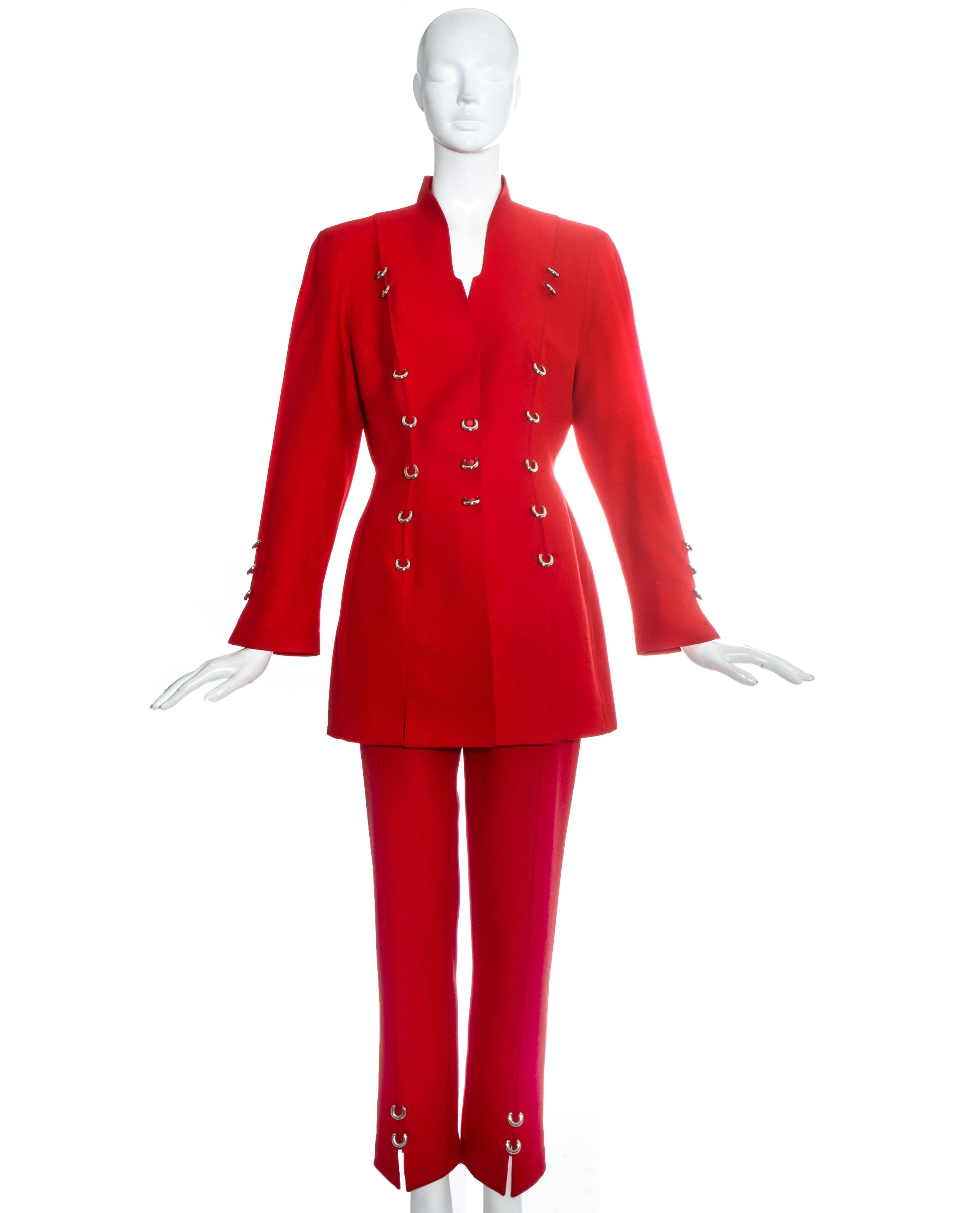 Thierry Mugler red pant suit with decorative silver metal rings.

c. 1990s