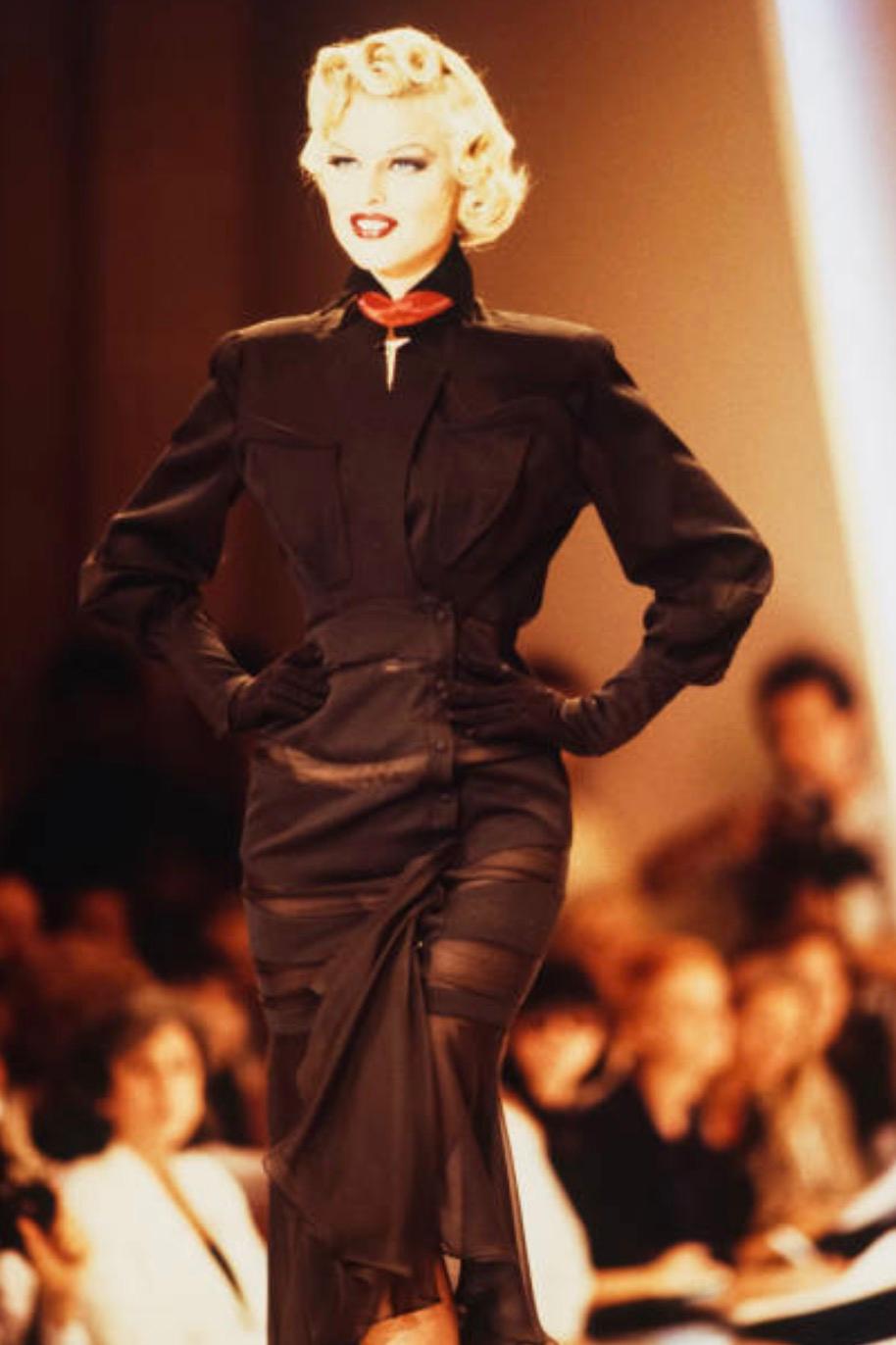 The perfect blend of pure Eelegance & Drama! Extremely rare FW 1992 Thierry Mugler ensemble, jacket and skirt.
In this exquisitely tailored two-piece, Thierry Mugler once again demonstrates his mastery of architectural silhouette and theatrical