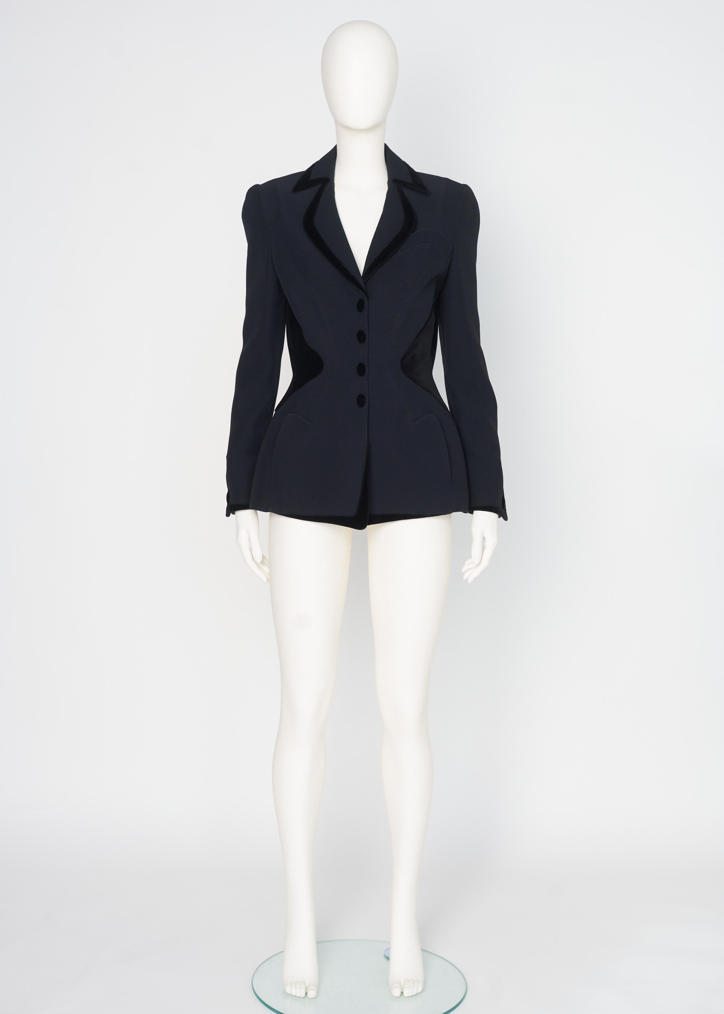 Probably from the unforgettable 1995-1996 Fall-Winter collection, this rare and stunning Mugler blazer jacket dates from the days when Thierry Mugler was one of Paris's most celebrated designers.
Made from black cotton (but feels like wool), the