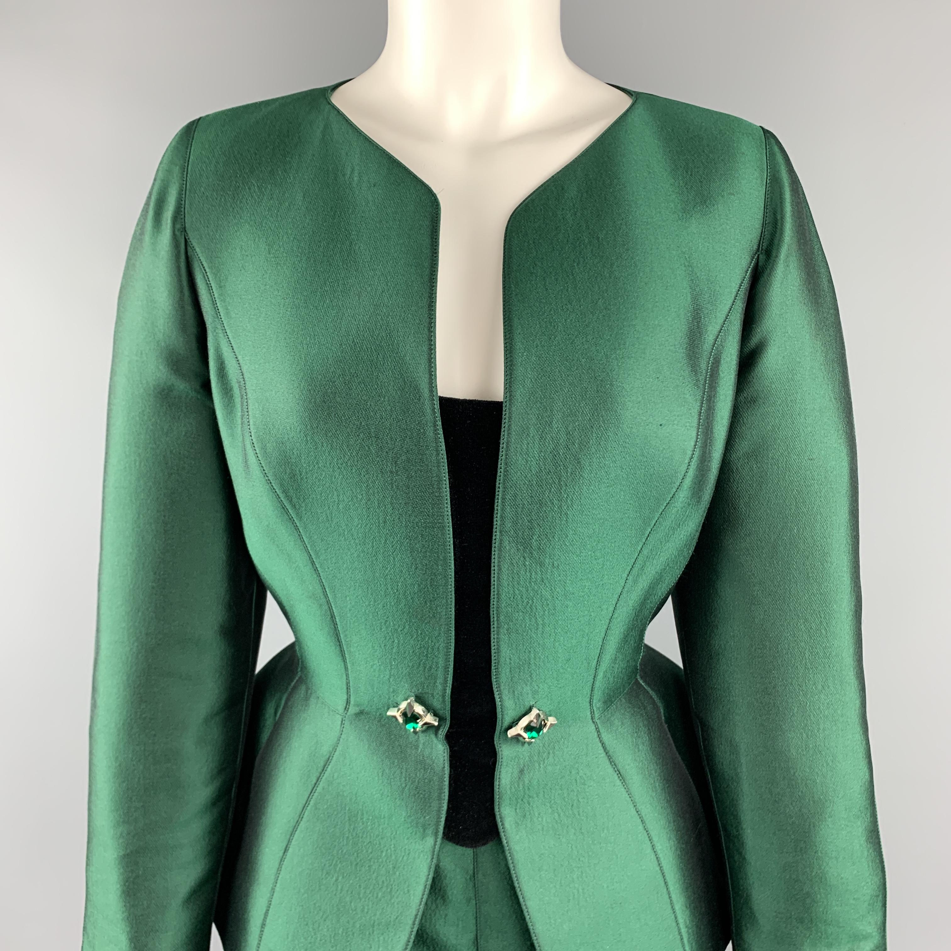 This gorgeous vintage 1980's THIERRY MUGLER skirt suit comes in forest green structured wilk wool blend satin and includes a collarless neckline, peplum, black velvet rhinestone embellished jacket and matching pencil skirt. Minor wear. Made in