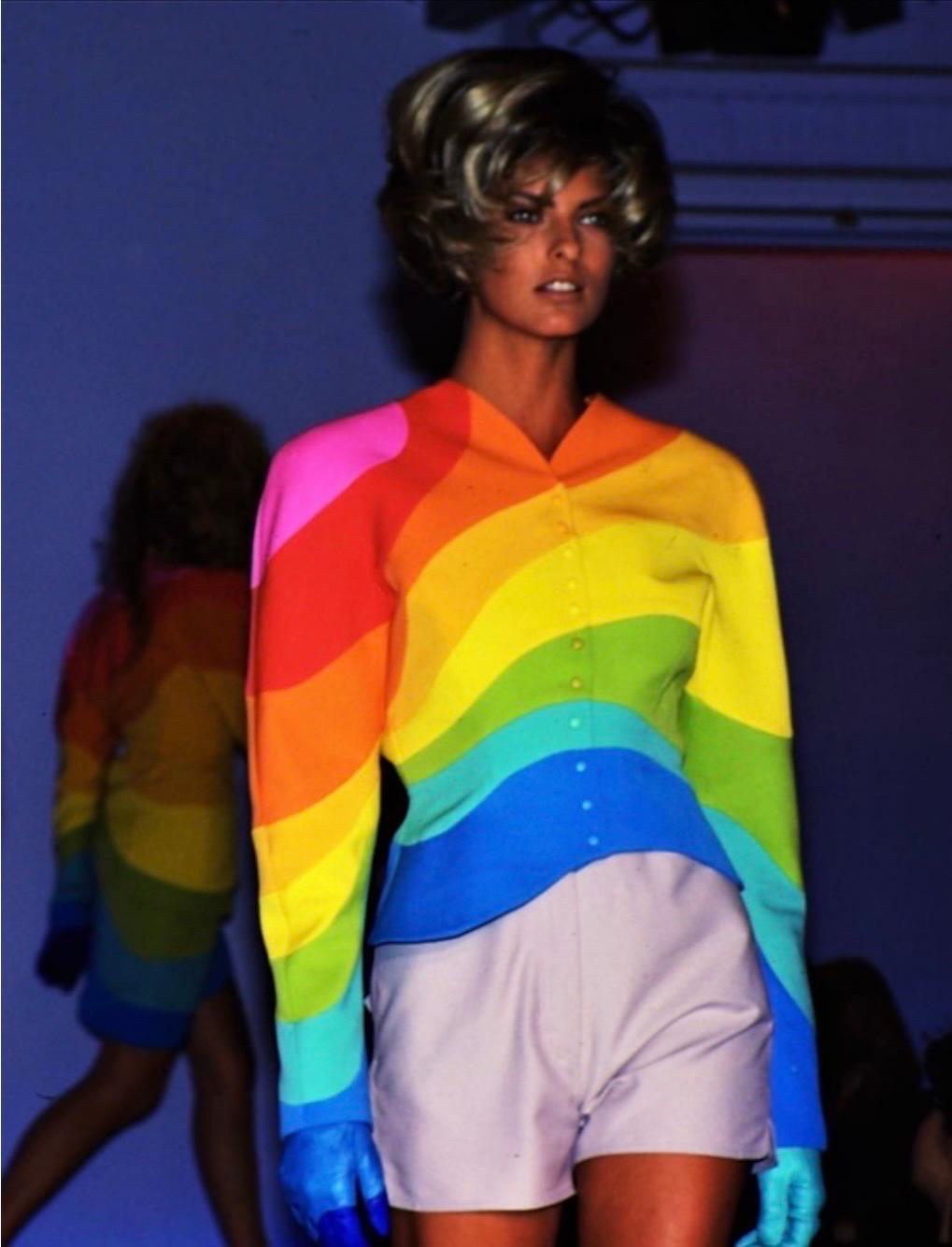 Own a true piece of wearable art and history!
Ultra rare museum worthy Thierry Mugler jacket from the Spring Summer 1990 Collection.
“Arc En Ciel” (Rainbow) in brushed woolen canvas with large multicolored waves.
Features a fitted cut with shoulder