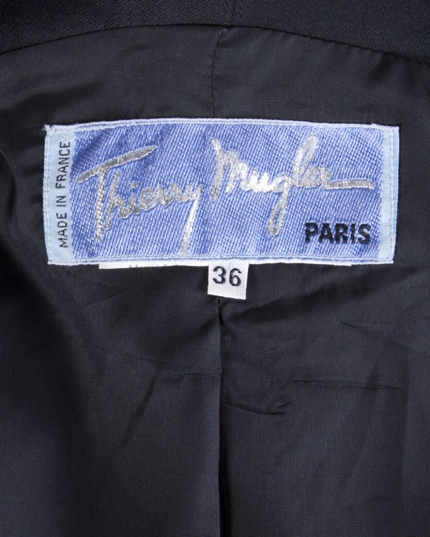 The perfect black blazer jacket by Thierry Mugler! Iconic Mugler shape and unique stitch detailing.

Details

Fully lined
Front snap button closure
Front pockets
Circa: 1980s
Label: Thierry Mugler
Marked Size: 36
Estimated Size: S
Colors: