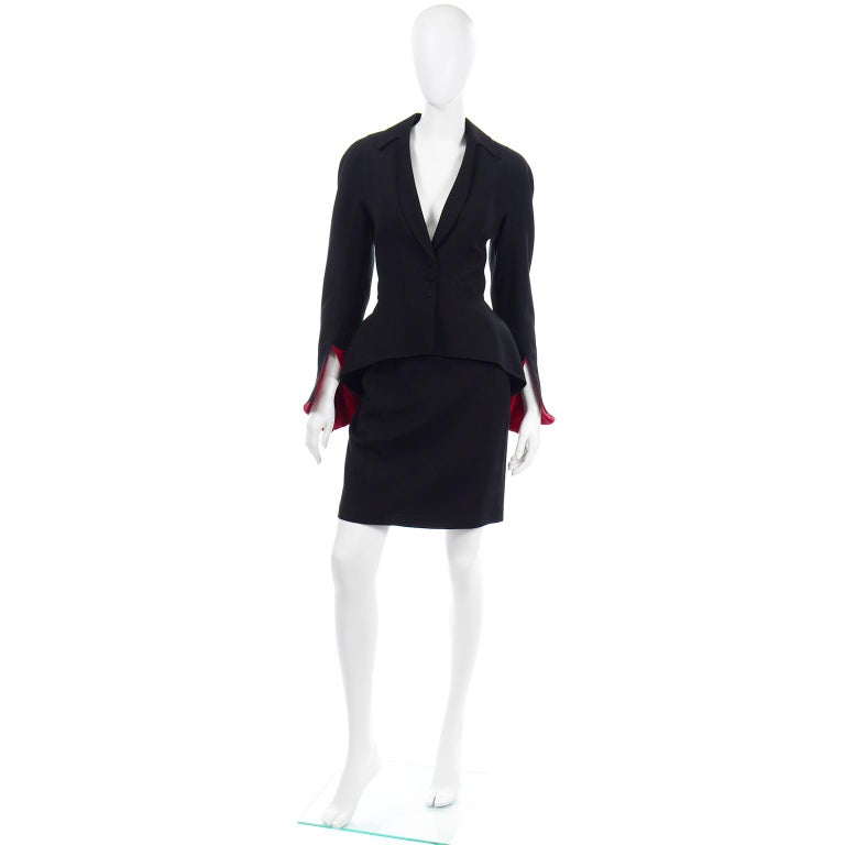 This outstanding vintage Thierry Mugler skirt and jacket suit is in a black worsted wool with fabulous red velvet lined split ruffled cuffs! This outfit is one of our favorite Mugler ensembles. The incredible jacket has the iconic Mugler silhouette