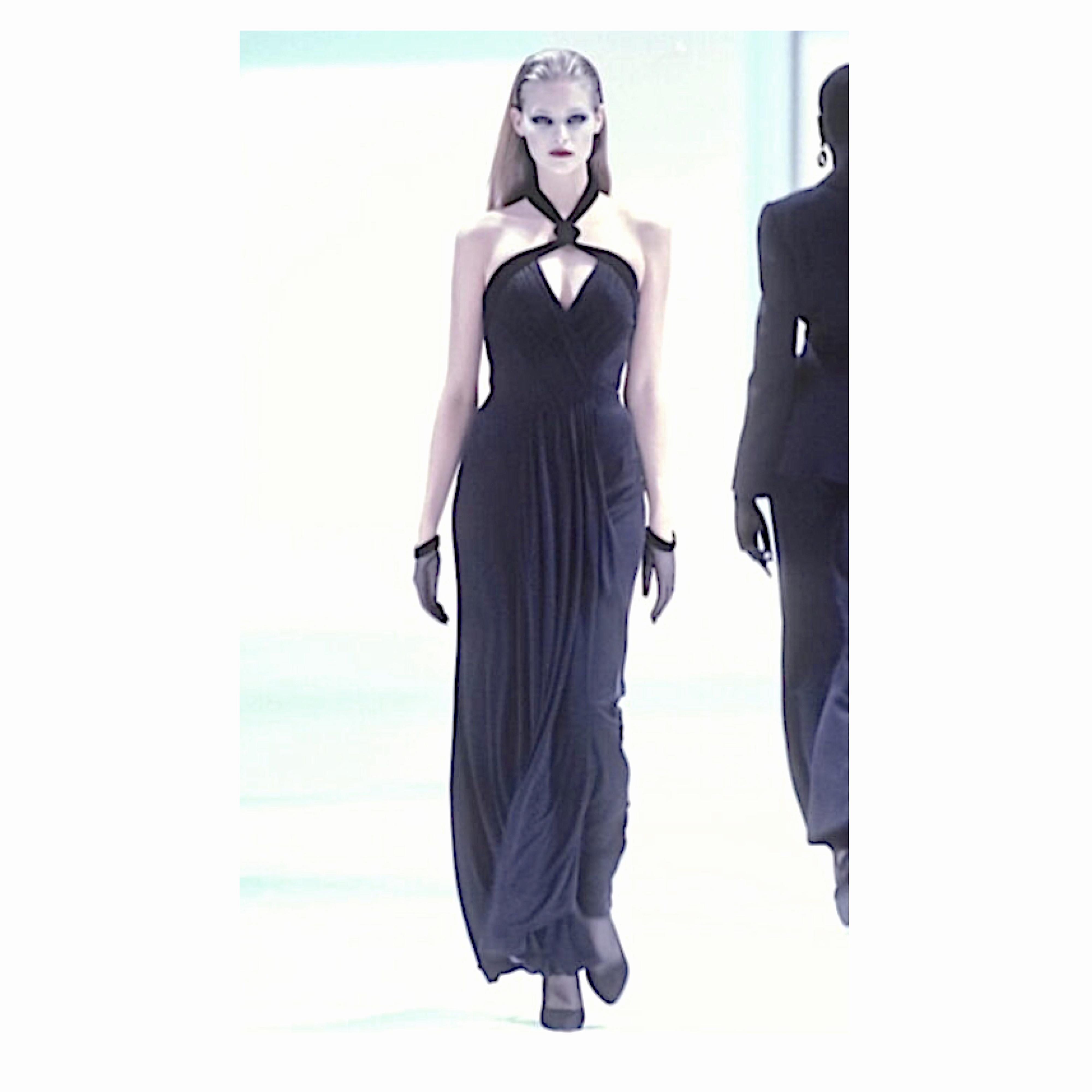 Collector's piece by Thierry Mugler
This stunning F/W 1998 gown from Thierry Mugler is made from a luxurious viscose jersey draped and sculpted with a built-in corset to hug the body. 
The gown has a pleated criss-cross neck built upon a structured