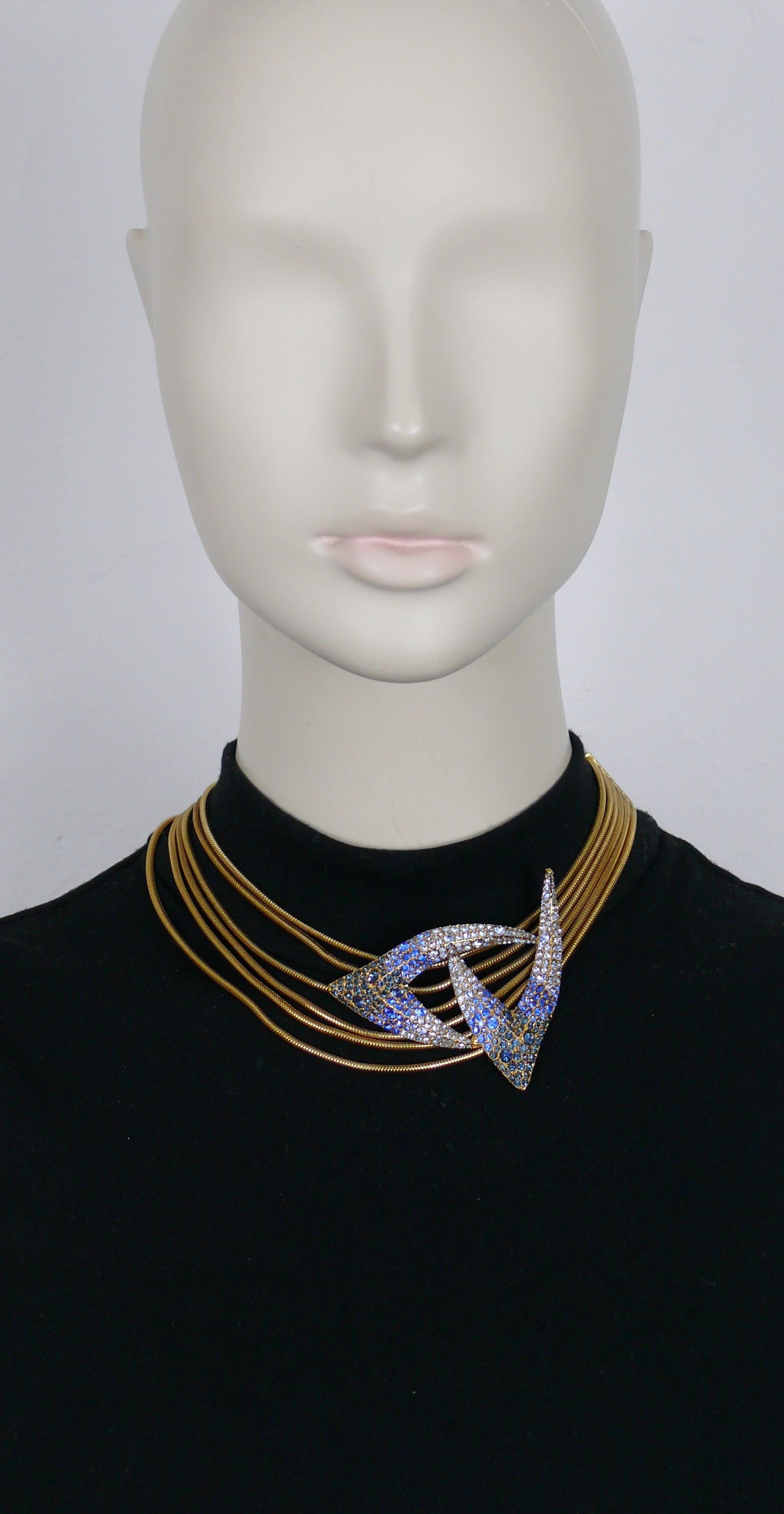 THIERRY MUGLER vintage gold tone snake chains collar necklace featuring a claw design centrepiece embellished with blue shade crystals.

Adjustable hook clasp closure.

Embossed THIERRY MUGLER.

Indicative measurements : length from approx. 35.5 cm