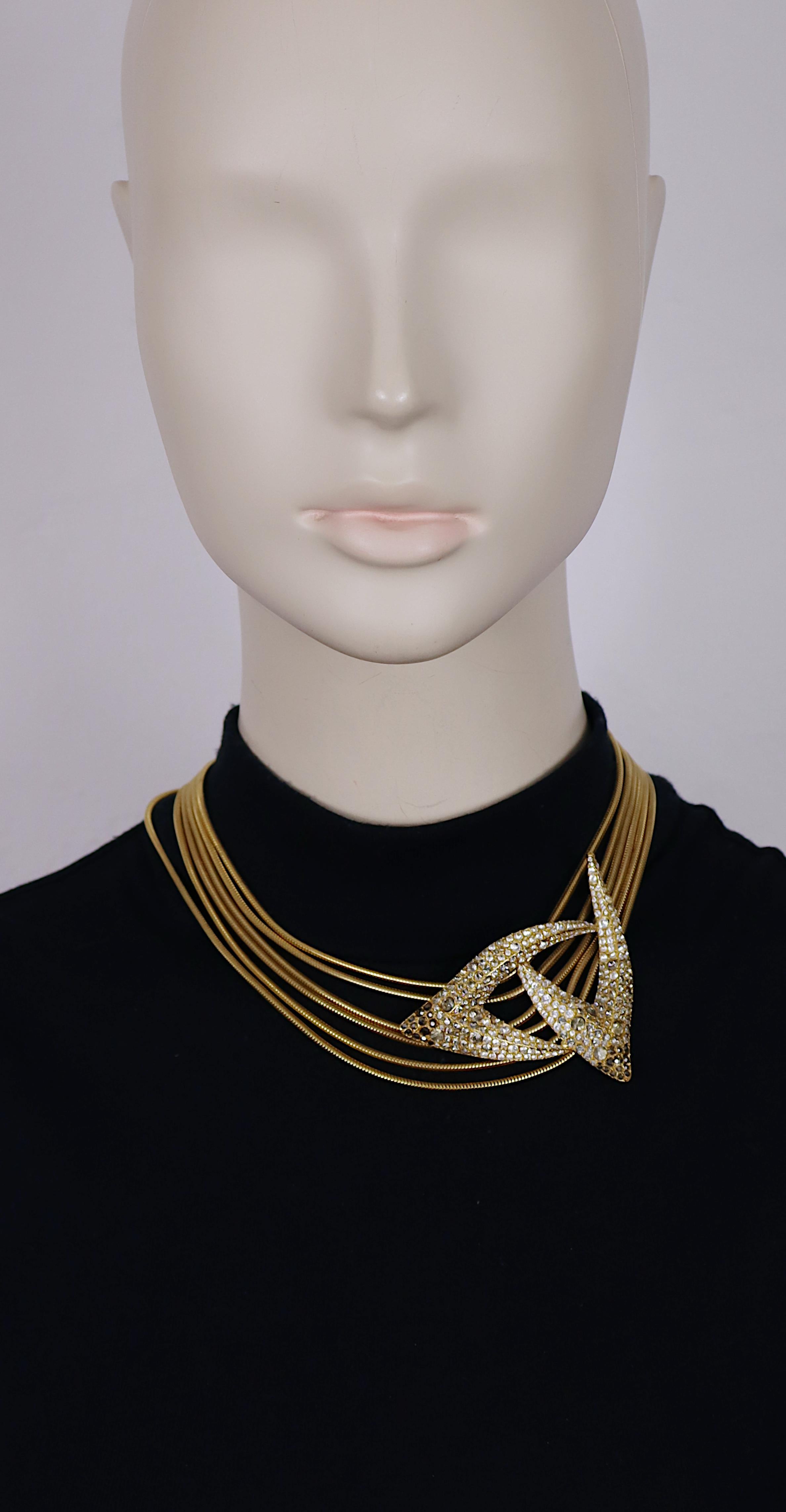 THIERRY MUGLER vintage gold tone snake chains collar necklace featuring a claw design centrepiece embellished with clear and grey shade crystals.

Adjustable hook clasp closure.

Embossed THIERRY MUGLER.

Indicative measurements : length from