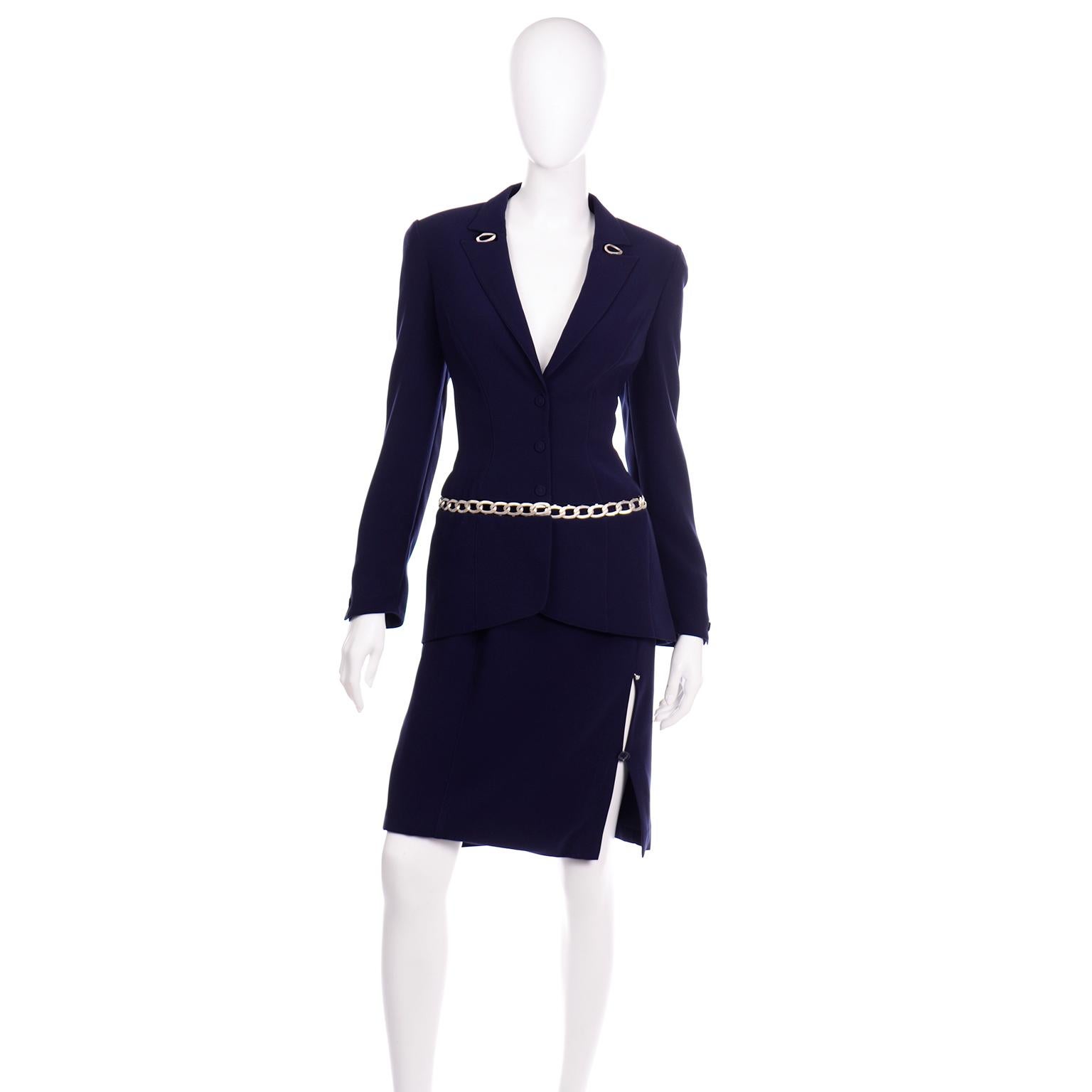This is such an incredible Thierry Mugler navy skirt suit in with a  matte silver-tone chain link detail. The jacket has fabric covered metal snap buttons in the center front opening and shoulder pads for structure. In classic Thierry Mugler