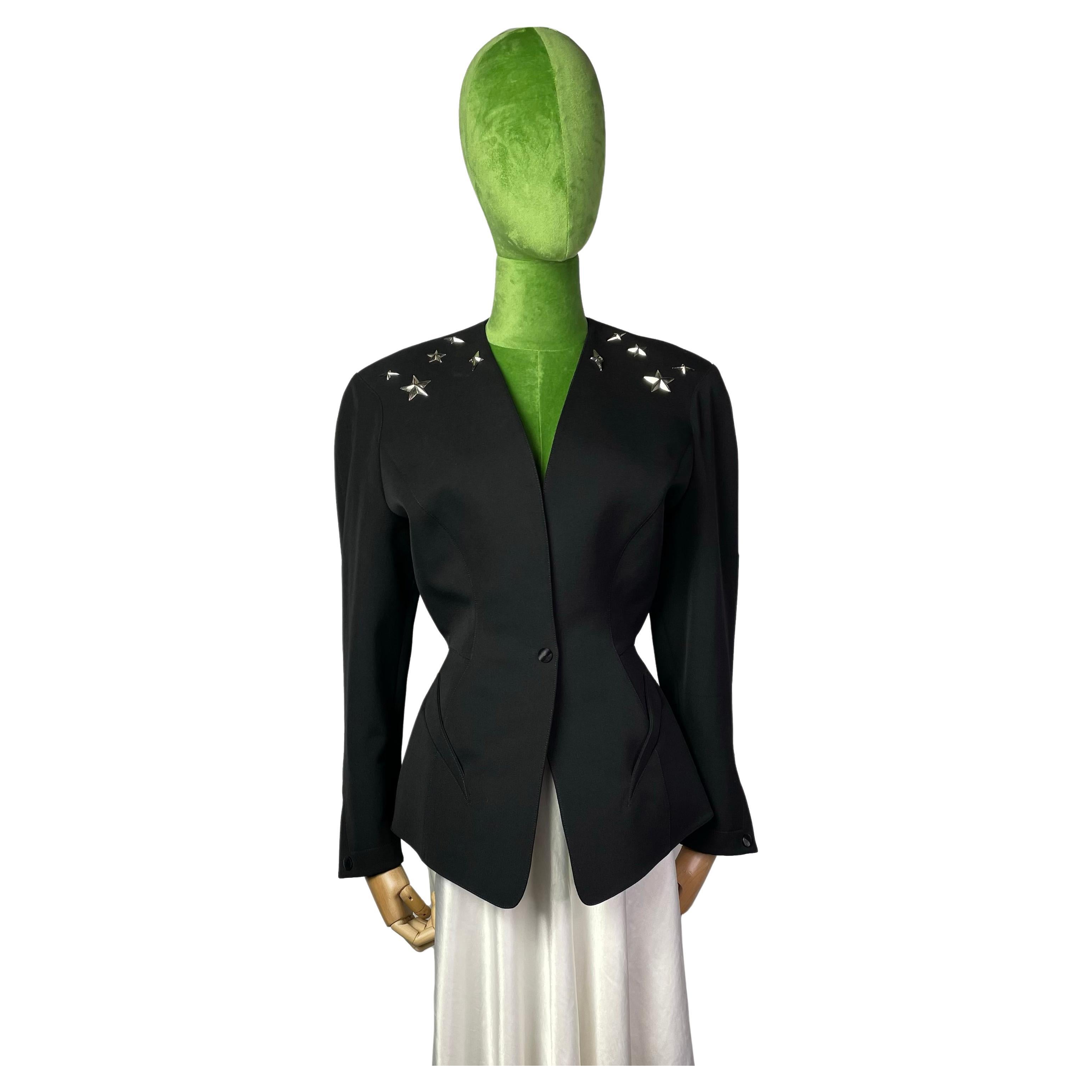 Vintage structured jacket by Thierry Mugler decorated with metal stars at the shoulders and on the back. 
Accented waistline, collarless. 
Slit Pockets. 
Button Closure. 
Condition: very good. Faint pilling throughout. Light discoloration at