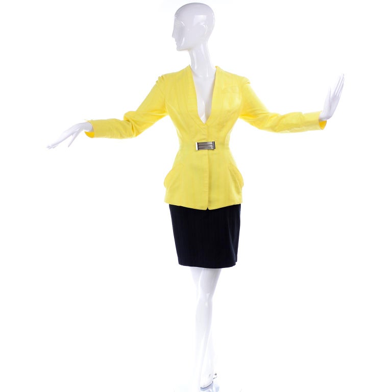 We love Thierry Mugler! This is a show stopping vintage Thierry Mugler 2 piece skirt suit with a slim tonal striped black cotton skirt and a tonal striped yellow cotton blazer. The skirt and jacket are both fully lined and the skirt closes with a