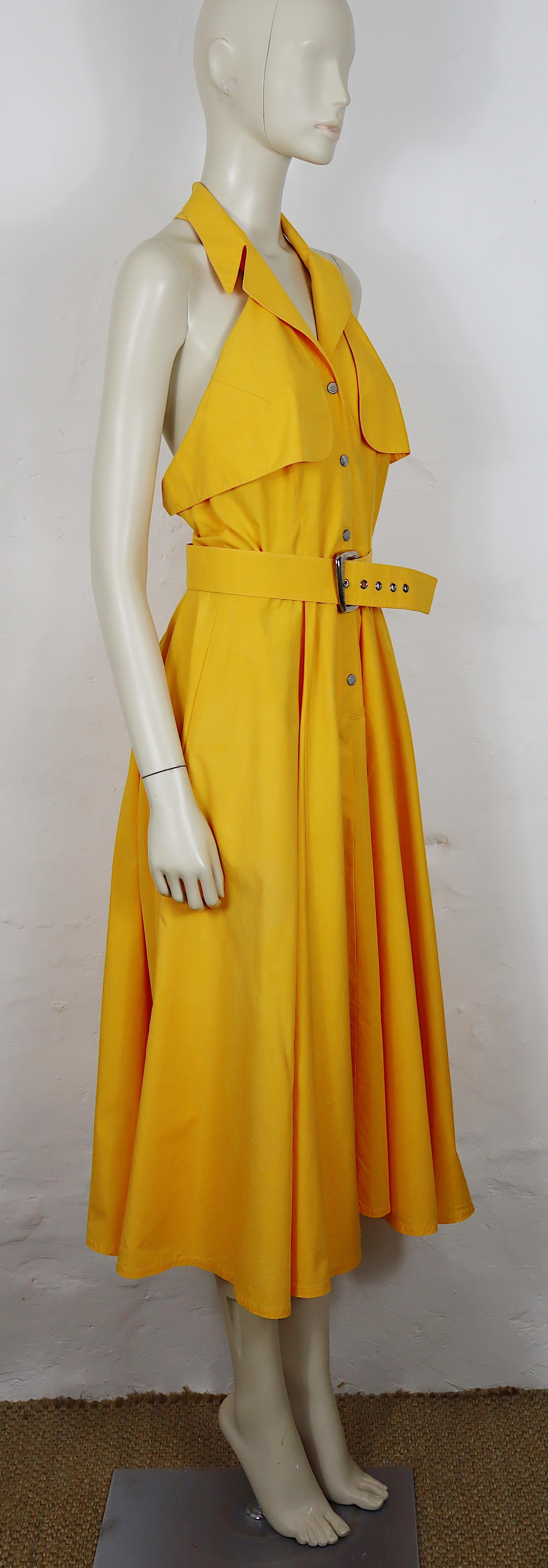 THIERRY MUGLER Vintage-Kleid aus gelber Baumwolle.

Dieses Kleid hat folgende Eigenschaften:
- Neckholder-Ausschnitt mit breitem, gekerbtem Revers, das eine tiefe V-förmige Vorderseite einrahmt.
- Geknöpftes Mieder mit silberfarbenen Metallknöpfen