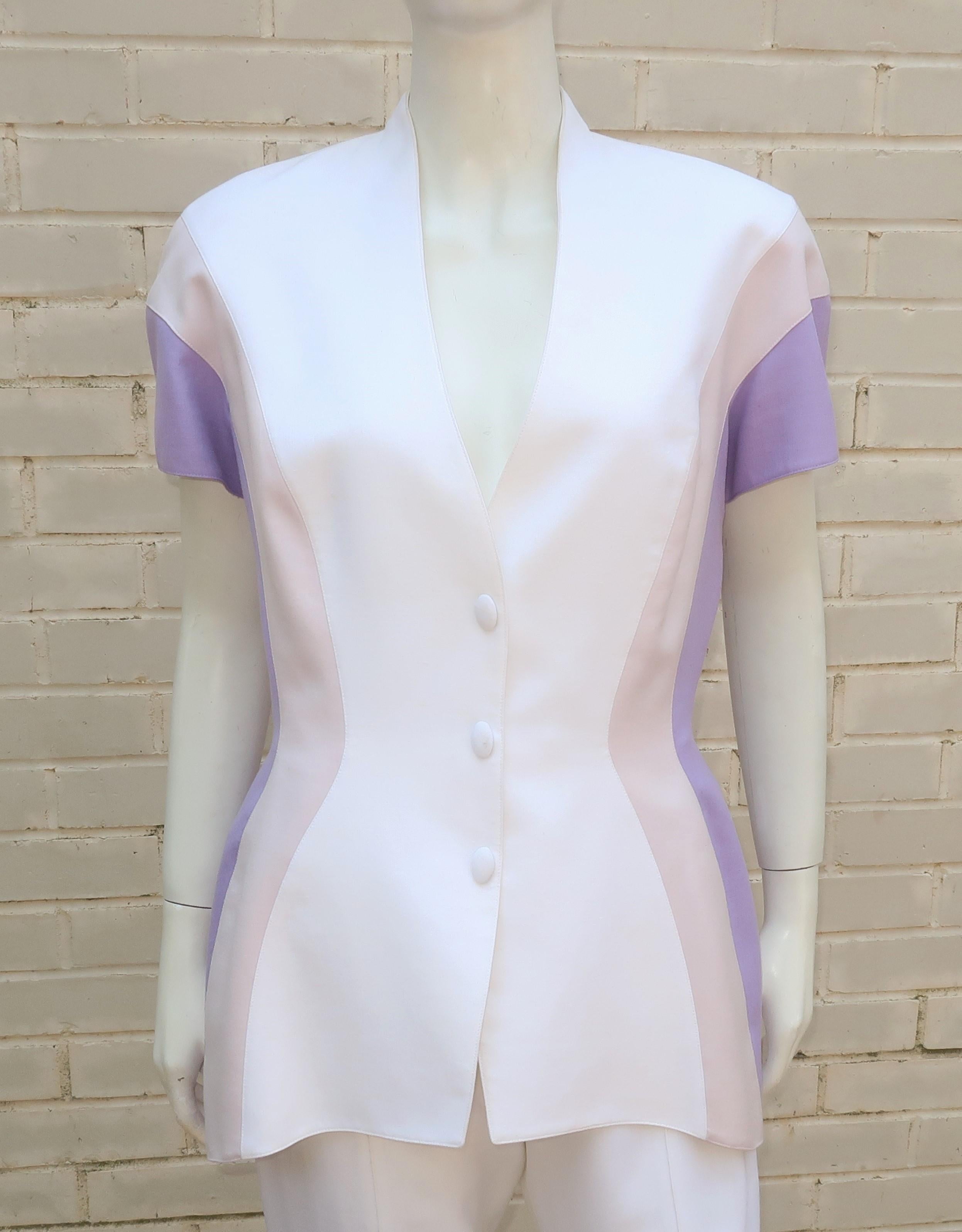 As with many of Thierry Mugler's designs, this 1980's linen suit is an inspired combination of a futuristic style with a nod to the strong silhouettes of the 1940's.  The short sleeved jacket has an elongated wasp waist shape with soft shoulder