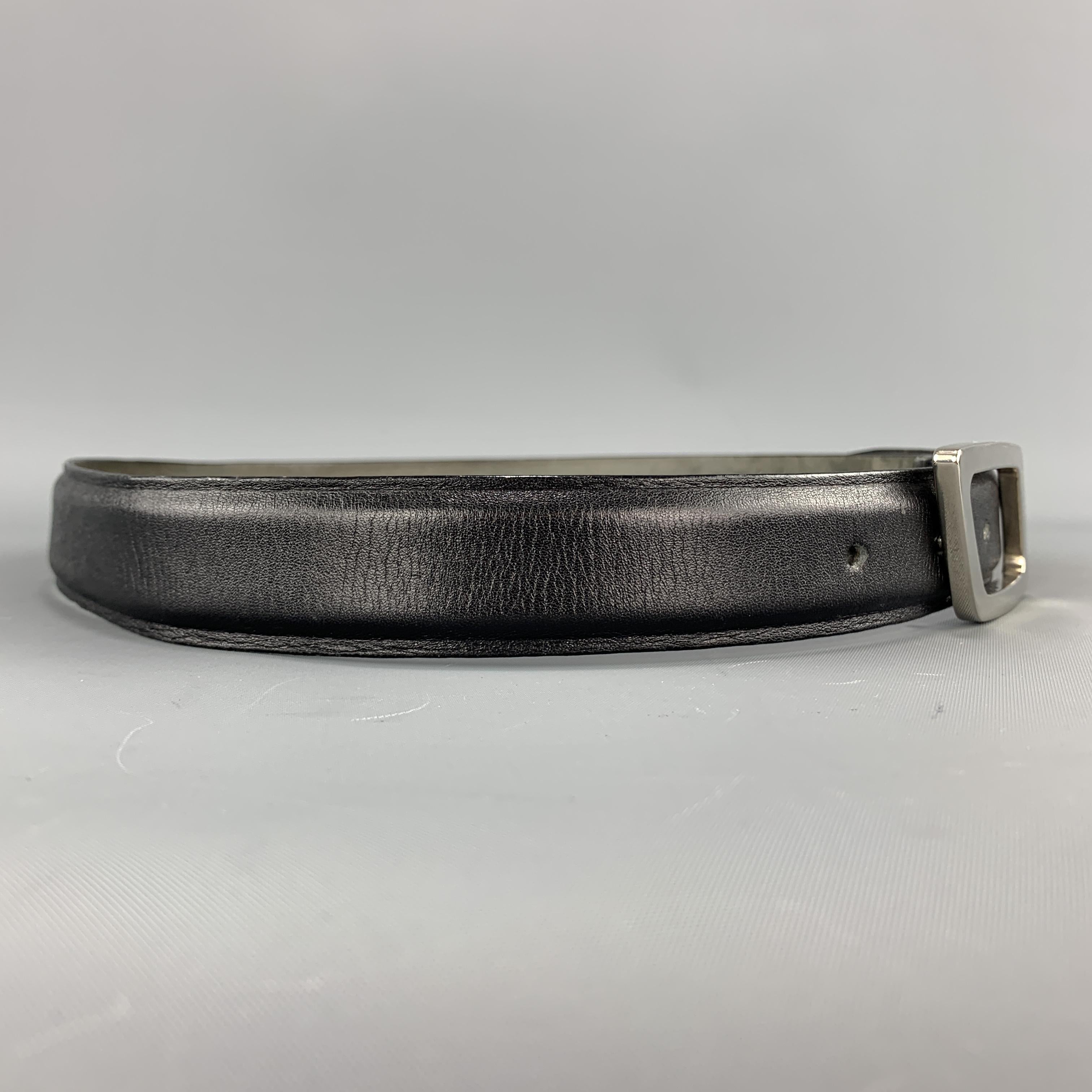Vintage 1990s THIERRY MUGLER dress belt features an embossed black leather strap with a silver tone cutout geometric shape buckle.

Very Good Pre-Owned Condition.
Marked: 90/36

Length:37 in.
Width: 1 in.
Fits: 28.5 - 33.5 in.
Buckle: 8.5 x 4 cm.