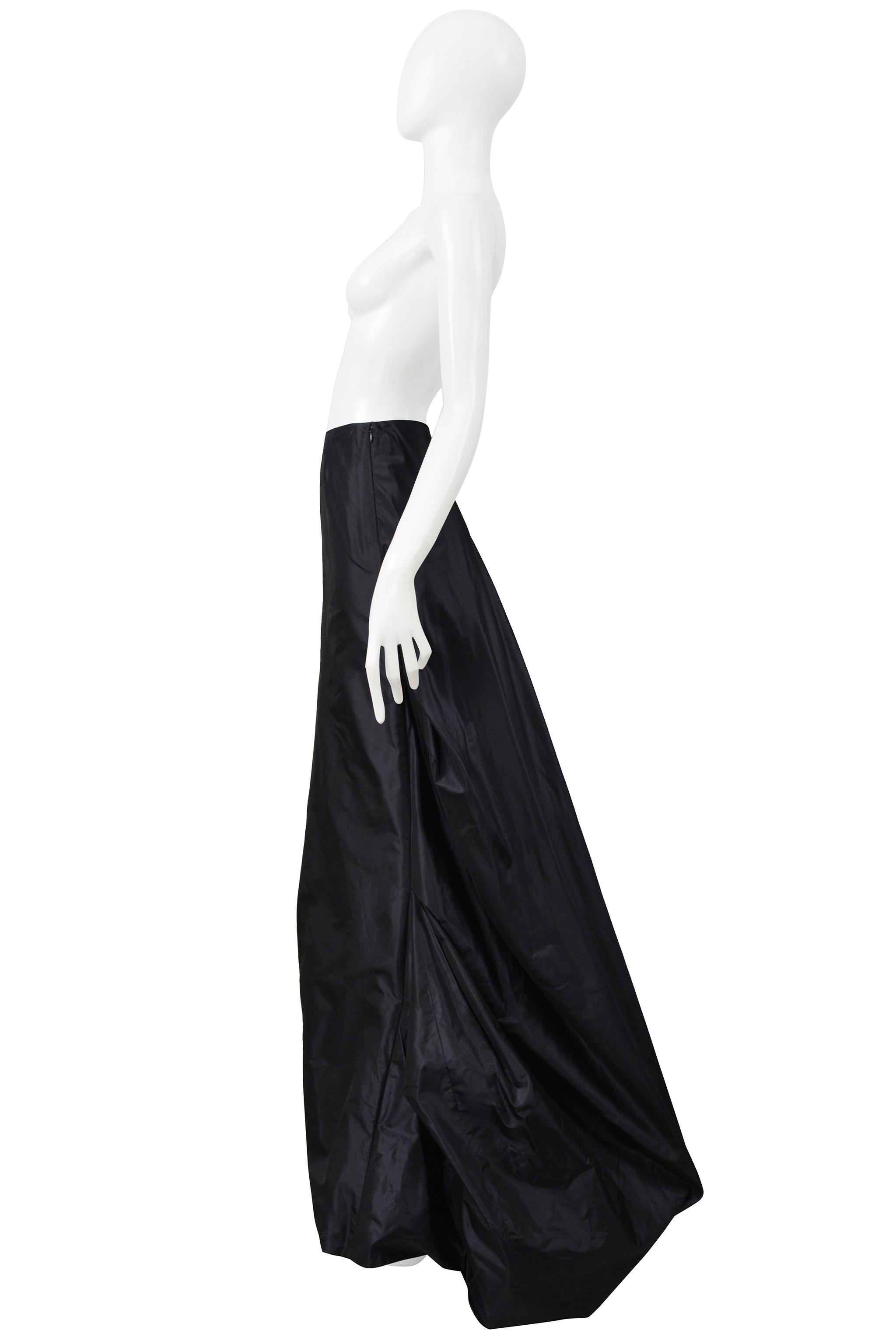 Resurrection Vintage is excited to offer a vintage black taffeta Thimister ballgown skirt with a flat front panel, dramatic side poufs, draped back panel, side zipper, and floor length.

* Thimister
* Size 38
* Fabric: 100% Nylon
* Excellent Vintage