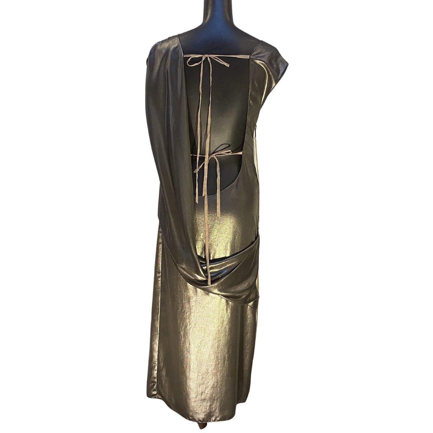 This vintage Thimister gown has a seductively revealing, draped back. It offers a heavy metal zipper with dangling ribbon pull and two more delicate ribbons to tie across the back, securing the shimmery sleeveless dress to the body.