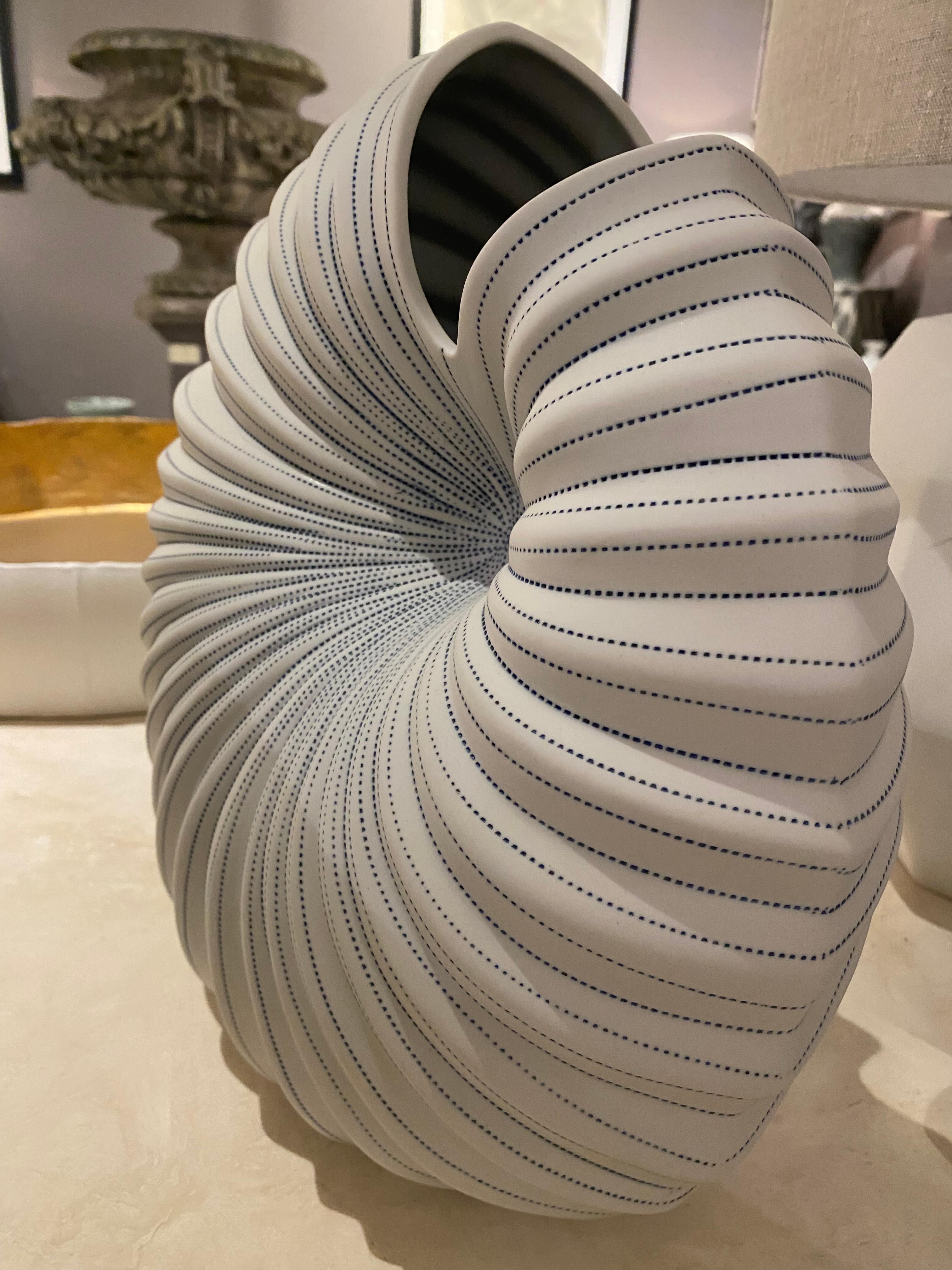 Contemporary Thailand thin blue and white striped vase.
Snail shaped design.
Can hold water.
Part of a very large collection.