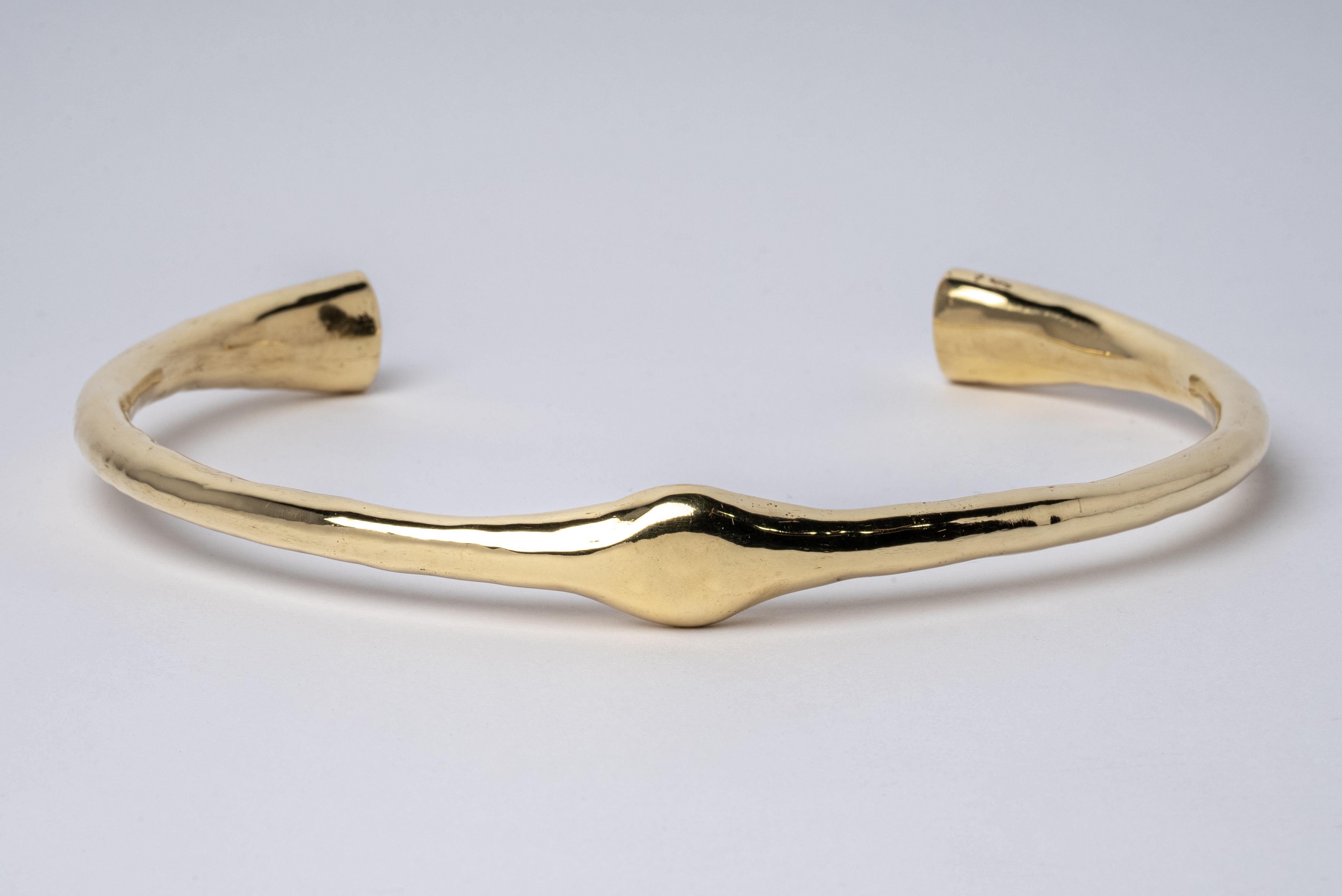 Choker in brass substrate, polished, and electroplated with 18k gold. This piece is 100% hand fabricated from metal plate; cut into sections and soldered together to make the hollow three dimensional form. This piece uses creation methods and