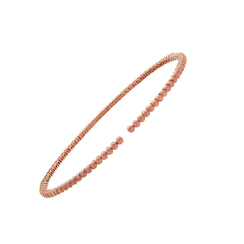Thin and simple, this discreet cuff still sparkles with round cut diamonds weighing at 0.87 carats. Completing the other half of the piece is a bead design on this all 18K rose gold cuff. 

Fits wrists up to 6.50 inches