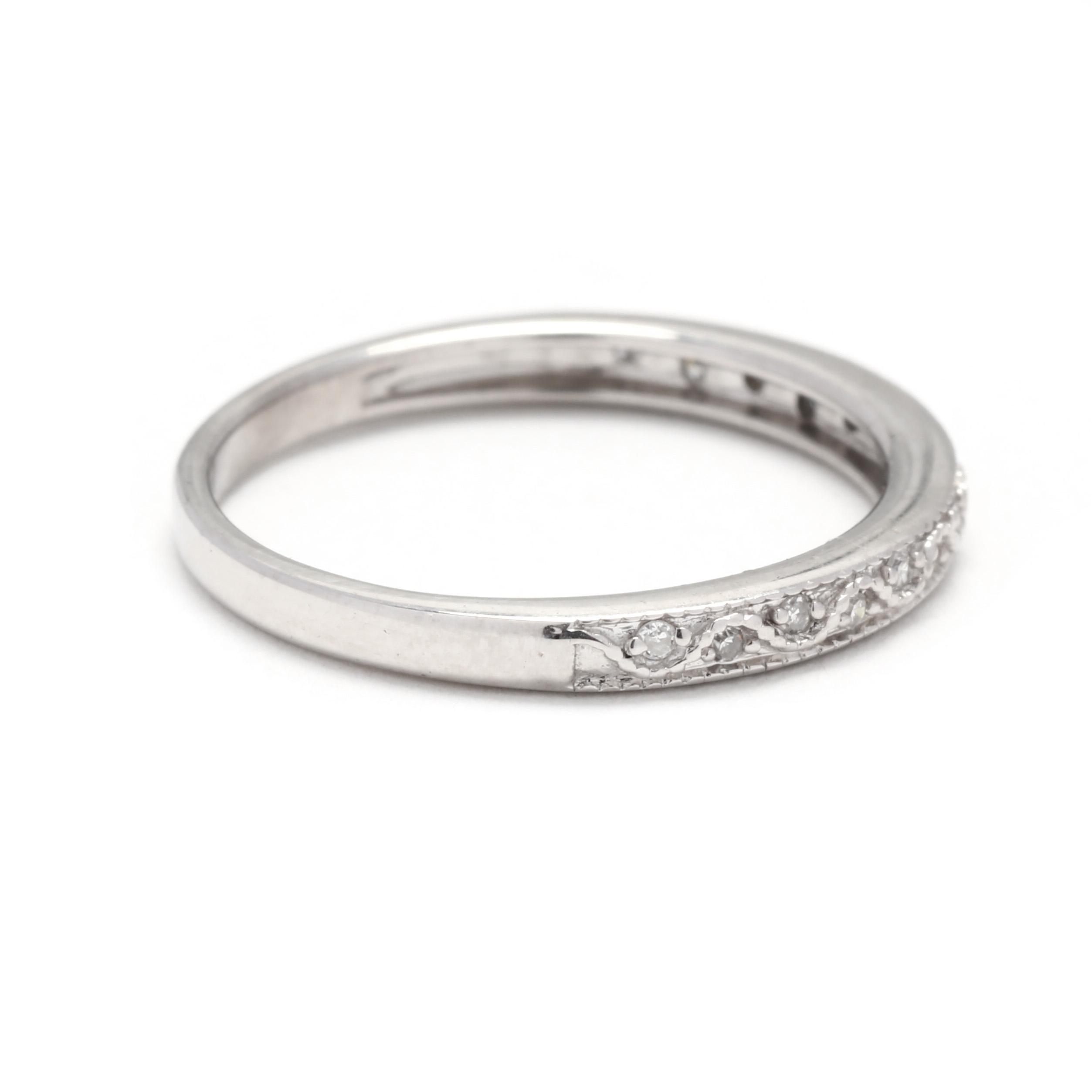 A vintage 10 karat white gold thin diamond wedding band. This stackable ring features a slightly tapered band with a wave design set with single cut round diamonds weighing approximately .05 total carats.

Stones:
- diamonds, 15 stones
- single cut