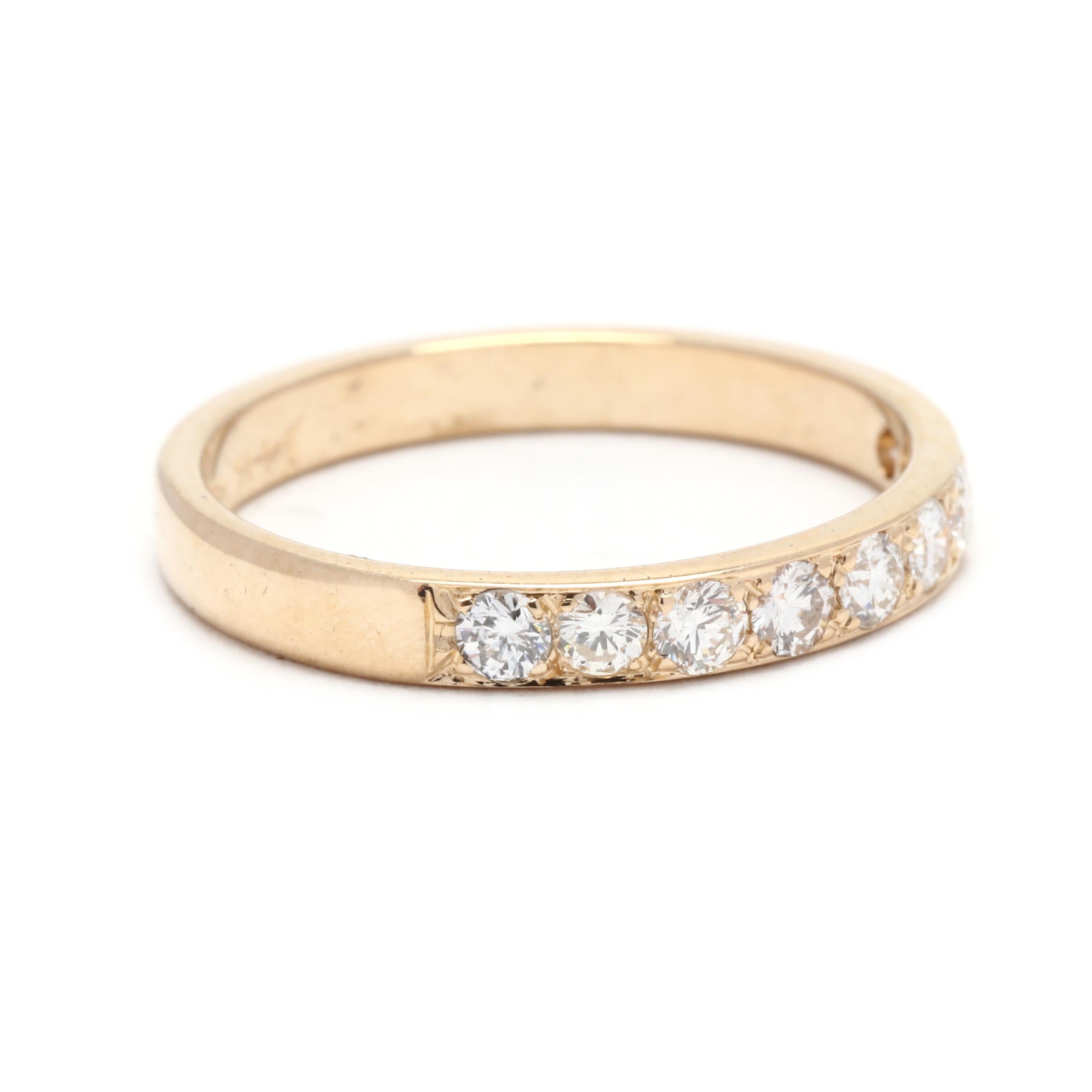 A vintage 14 karat yellow gold thin diamond wedding band. The stackable band features a straight design with bead set, round brilliant cut diamonds weighing approximately .36 total carats.

Stones:
- diamonds, 9 stones
- round brilliant cut
- 2.3