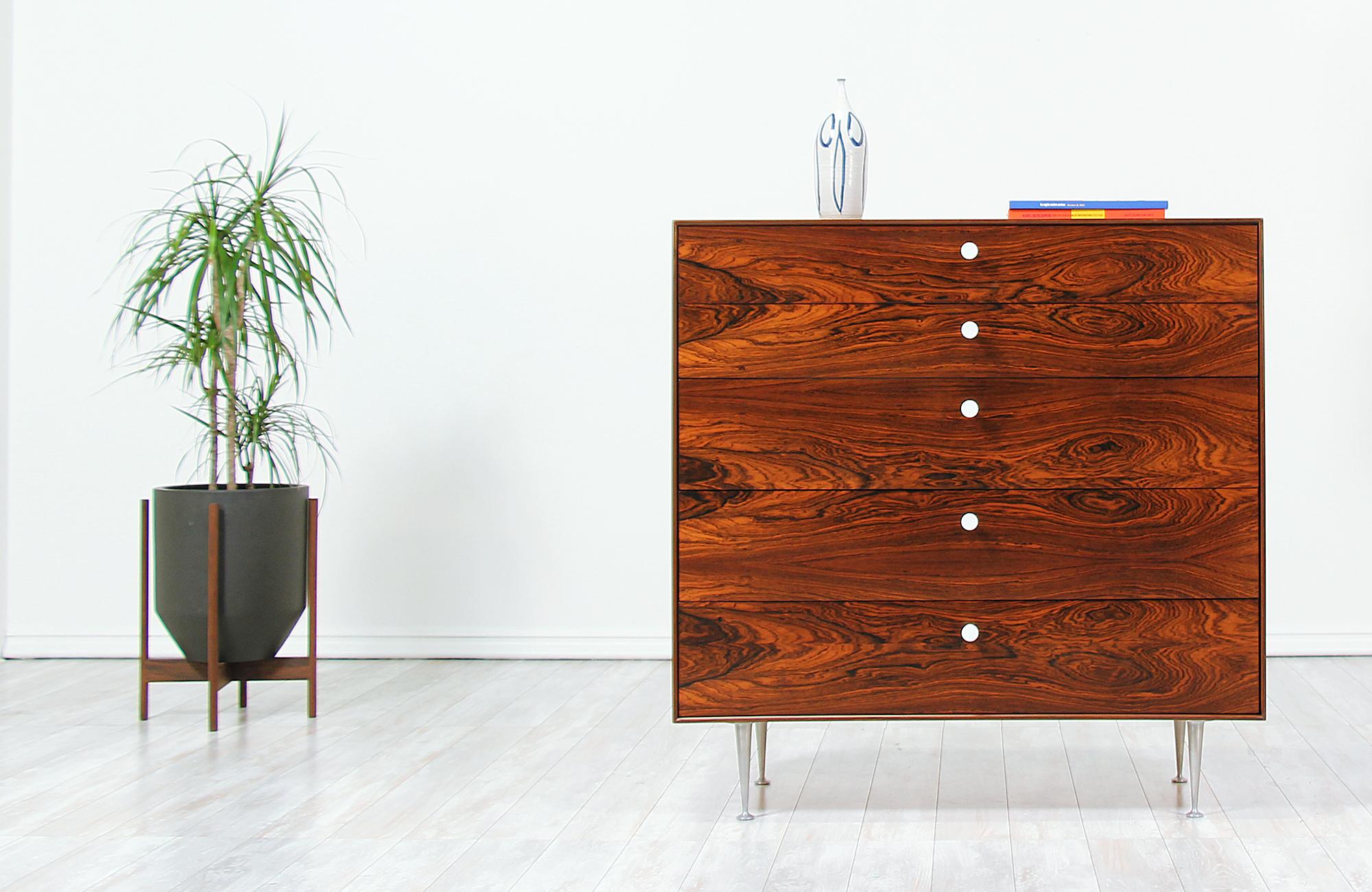Stunning chest of drawers designed by George Nelson for Herman Miller in the United States circa 1950s. Just like the rest of his 'Thin Edge' collection for Herman Miller, this beautiful rosewood chest features a solid frame with five drawers and