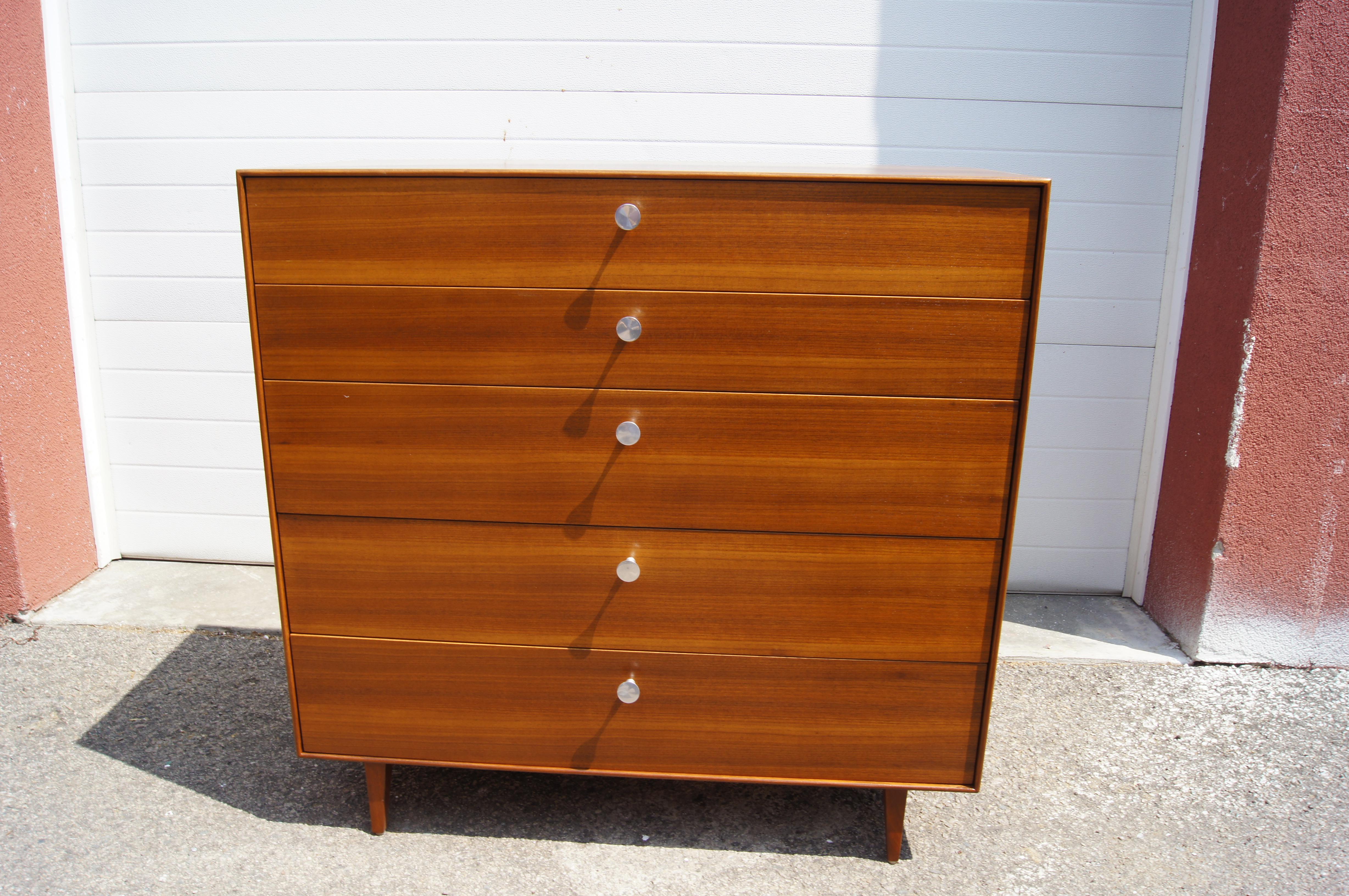 This gorgeous dresser is part of George Nelson's 1950s Thin Edge collection for Herman Miller, which takes its name from the elegant, slim profile. Tapered trestle legs elevate the walnut case, whose five drawers, three deeper at bottom and two