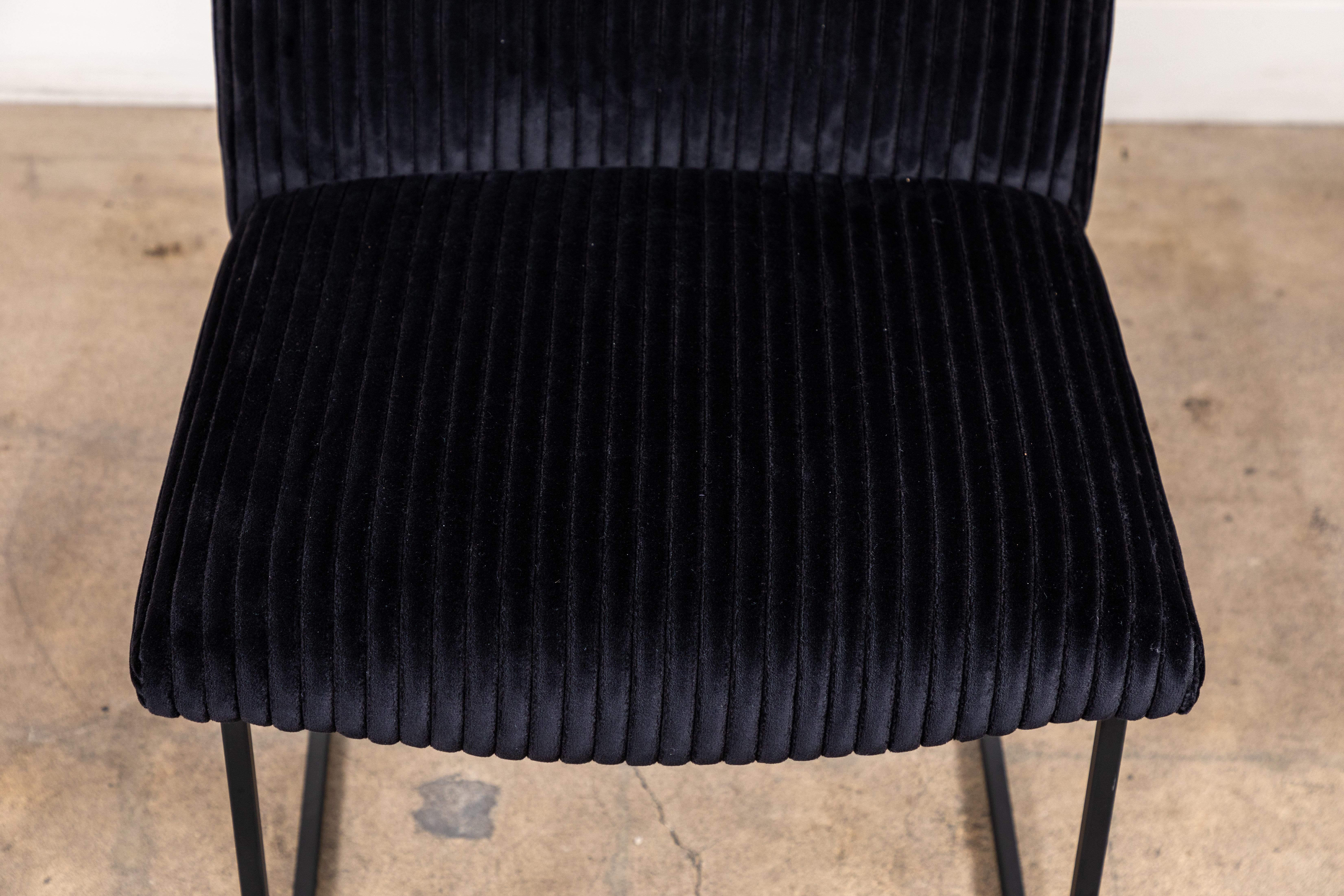 The thin frame dining chair features a high back and an armless silhouette that rest atop a thin metal base. Shown here in black wide whale corduroy and a matte black powder coat base.

Available to order in Customer’s Own Materials with a 6-8 week