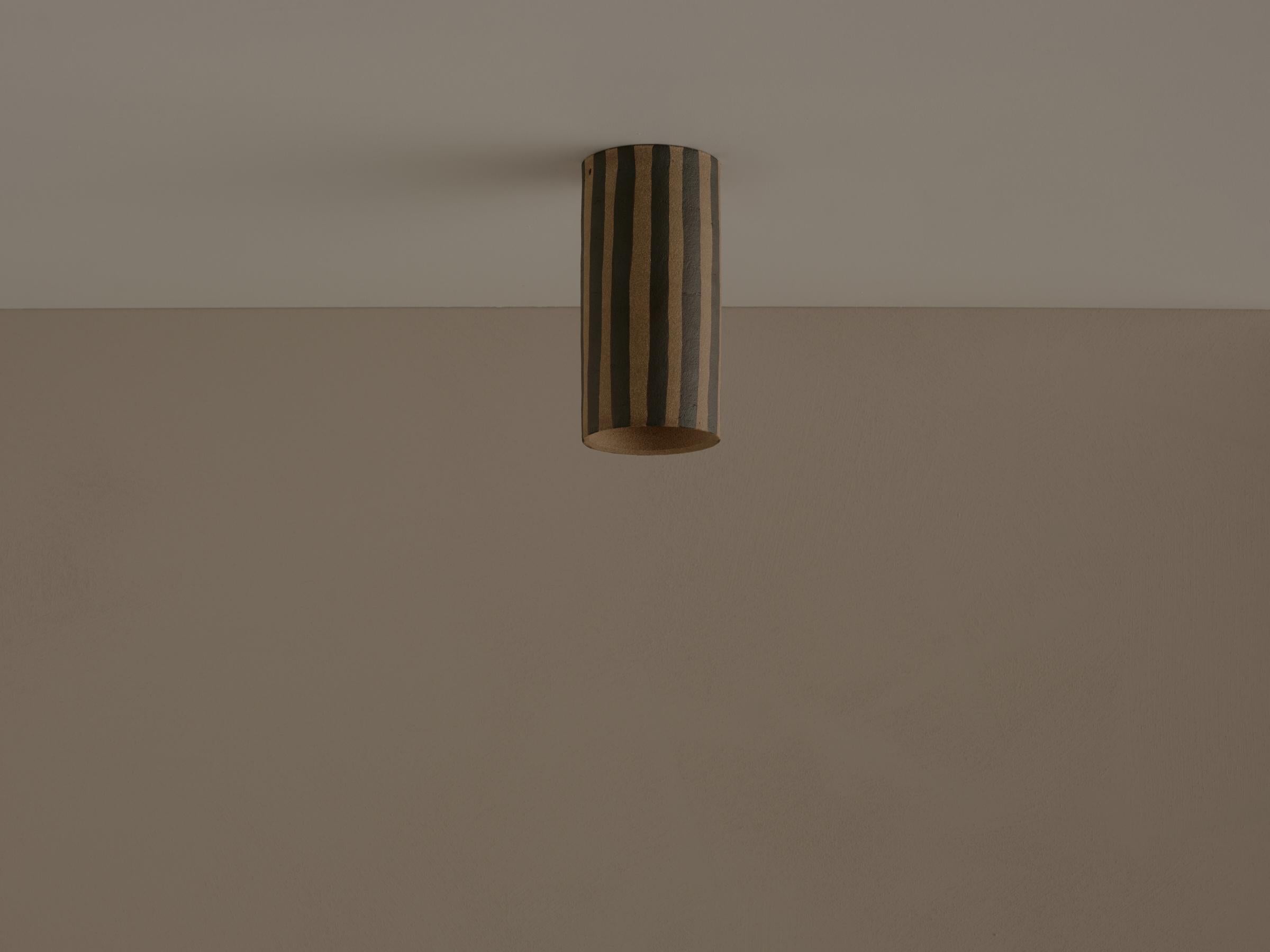 Thin Stripe Dancer Mounted Ceiling Lamp by Coco Flip
Dimensions: D 9 x H 18 cm
Materials: Clay, Brushed with black iron oxide. 


Dancer takes inspiration from the triadisches ballet developed by Oskar Schlemmer, who was part of the bauhaus design