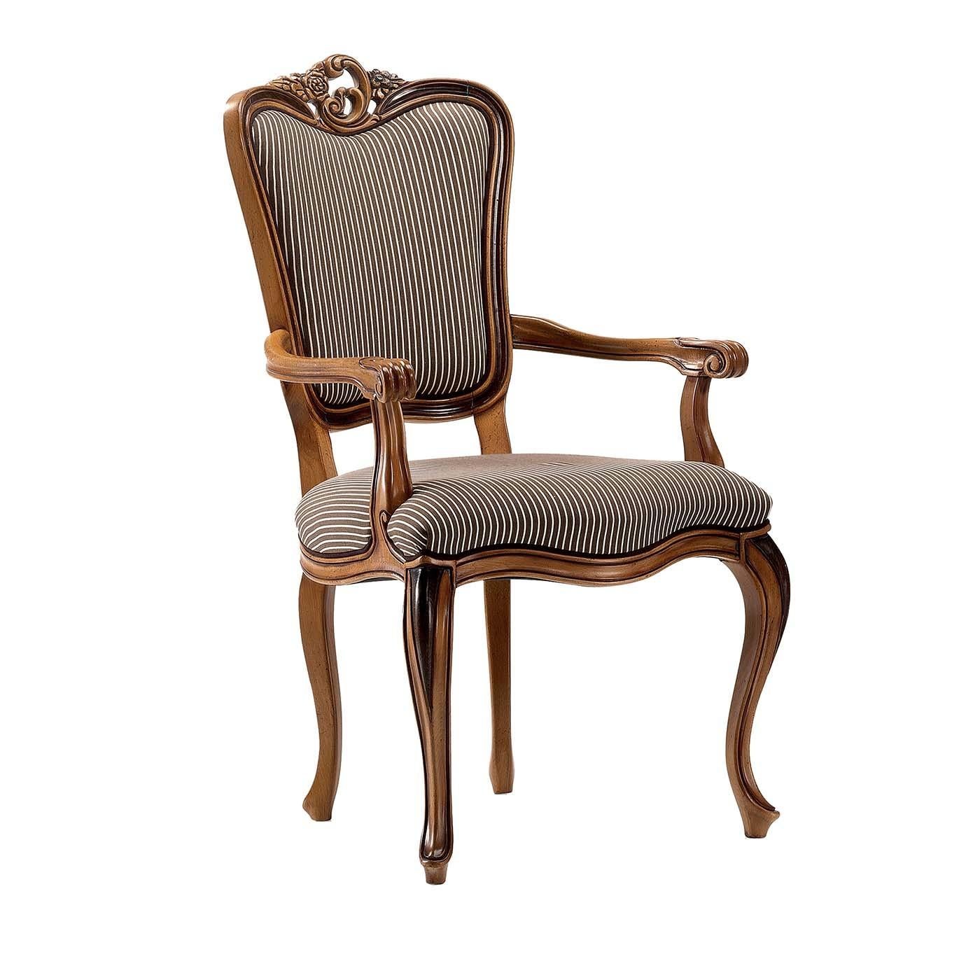 A superb homage to the Louis XV chair, this elegant chair with armrests is a splendid addition to showcase in a Classic interior as a dining chair, near a study desk, or as an accent piece in an entryway. Its elegant allure comes from the ornate