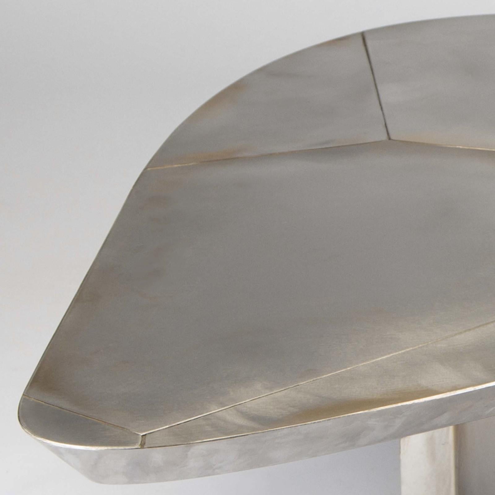 This unique and sophisticated coffee table is part of the Thinking Klein collection, inspired by the work of French artist Yves Klein. It was crafted entirely of steel with a multifaceted base that supports a strikingly textured top with an