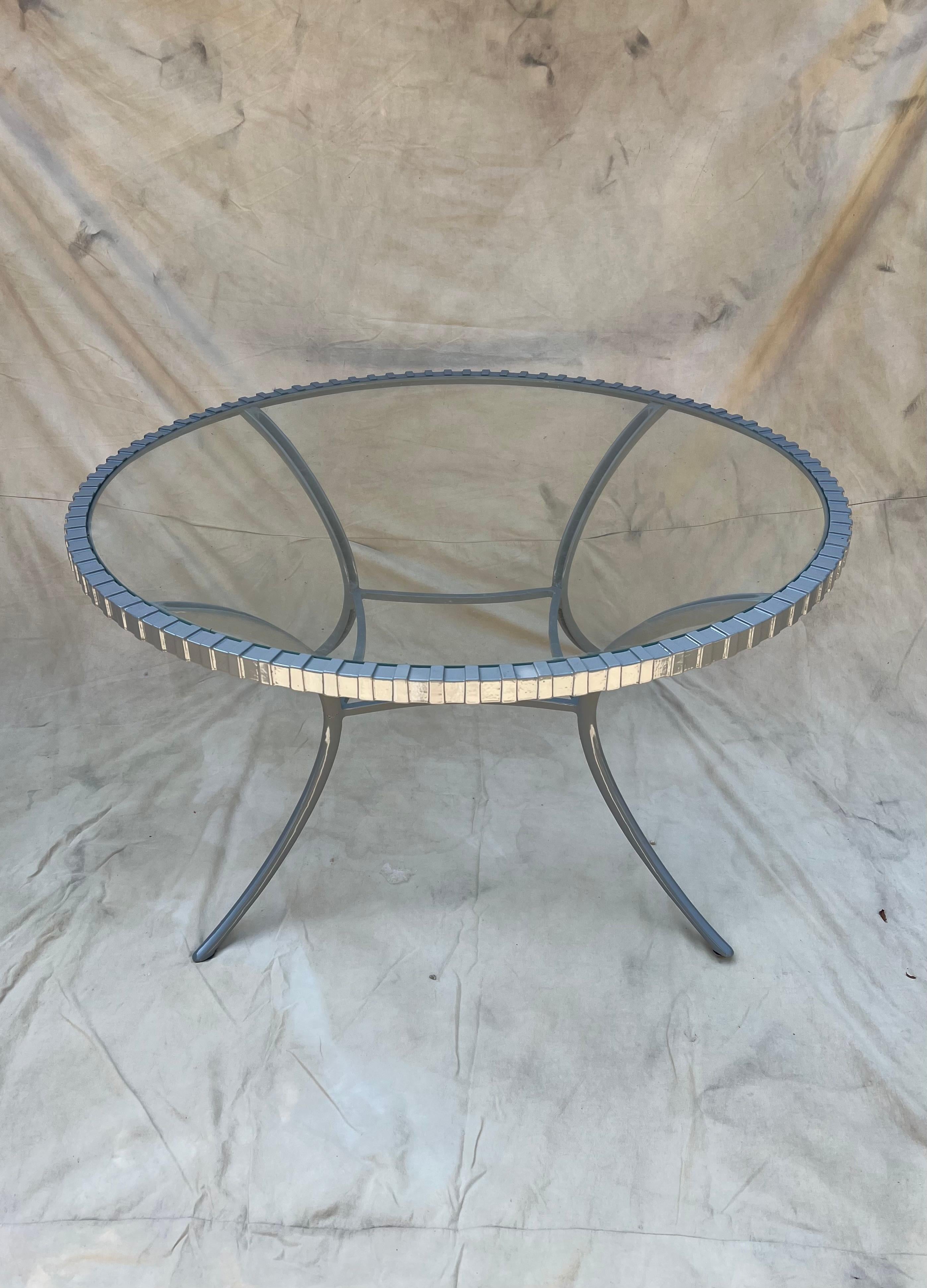 A classic Mid Century table - the Thinline table is a beautiful representation all the way around - from the clever notched perimeter to the klismos leg. We have recently powder coated the piece and also have 5 matching Klismos chairs that will be