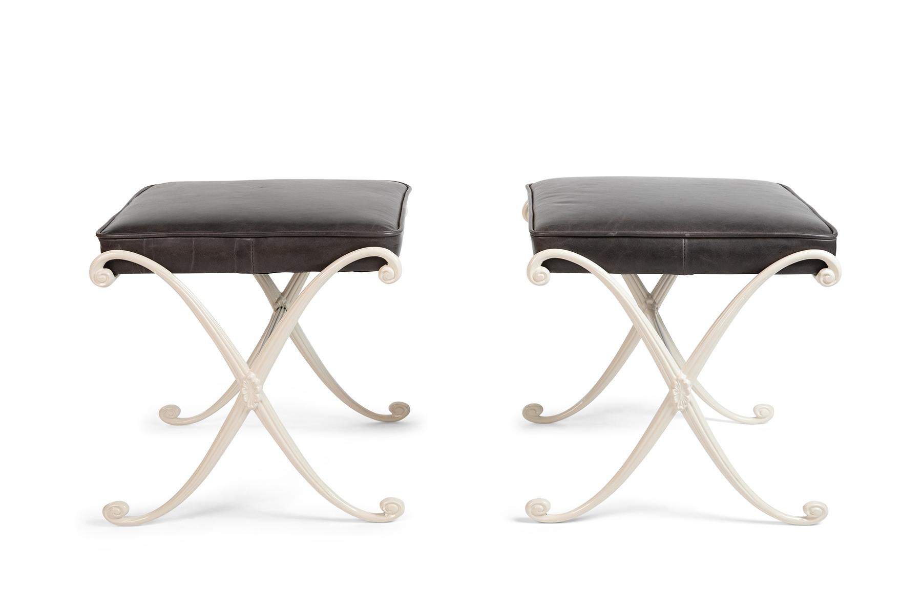Pair of Thinline leather and aluminum ottomans circa early 1960s. These examples have been newly upholstered in a supple charcoal leather and newly powder-coated in ivory.
The stretcher bar on one of these has texture and the other is smooth. Price