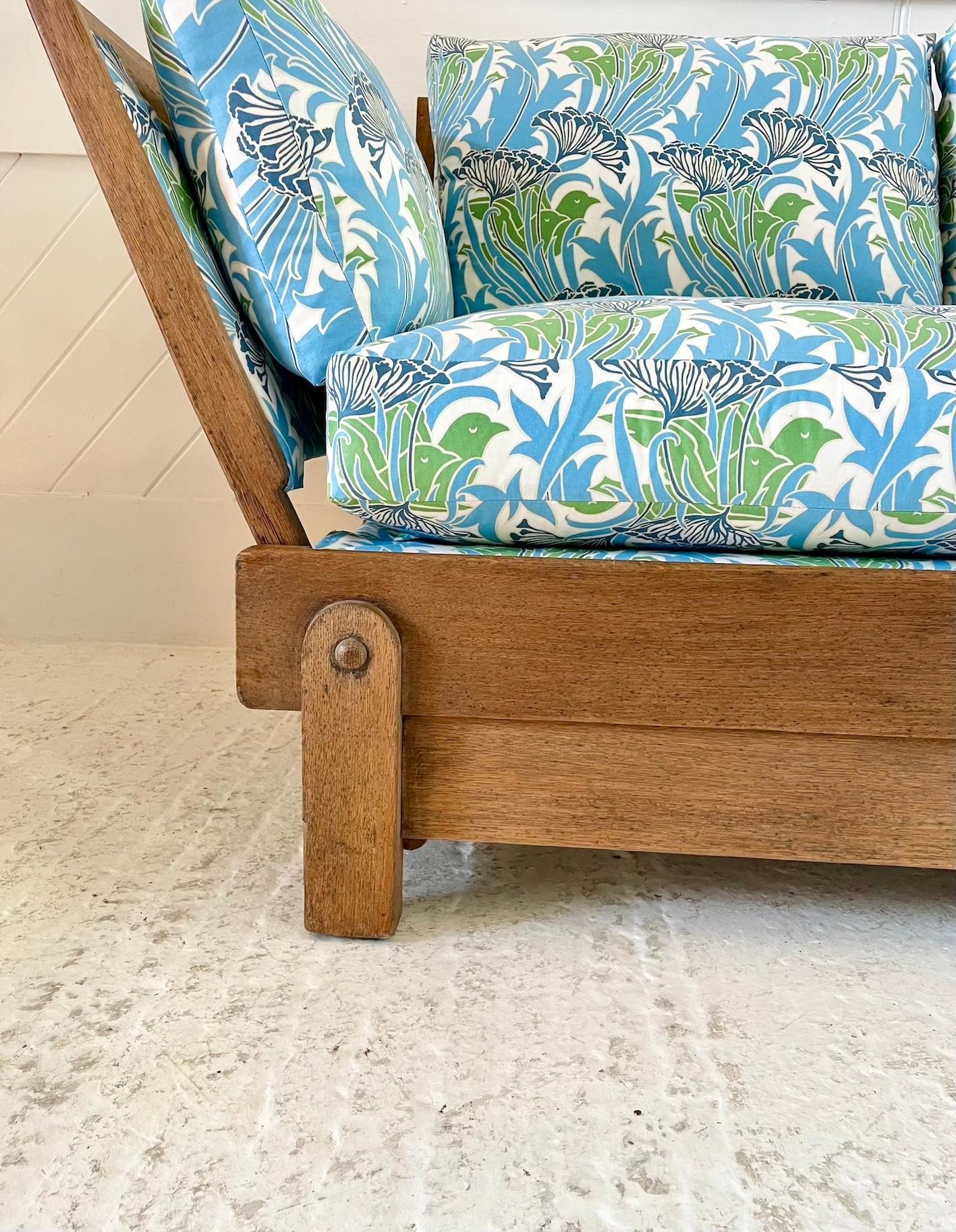 Thirties drop sided settee, converting into a day bed

The frame is solid oak with cloth covered spring to the seat and drop sides

Re-upholstered in a Voysey design cotton fabric

Manufactured by Parker Knoll

Retailed through Heal & Son

Circa