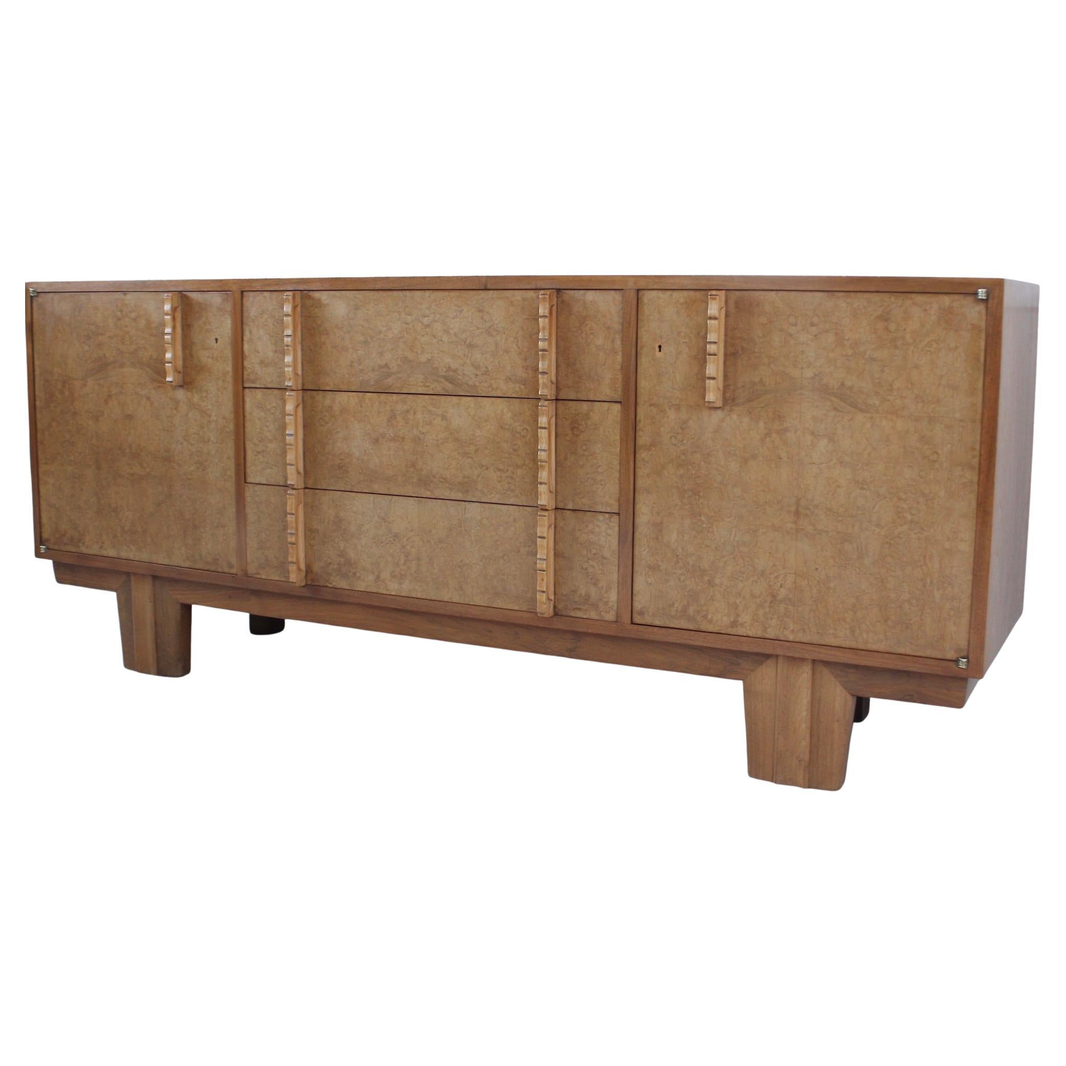 Thirties modernist sideboard in Hungarian ash, walnut and oak
Oak handles and brass hand made hinges
‘Heythrop Sideboard’
Designed by W. H. Russell for Gordon Russell
Circa 1935

The ‘Heythrop’ sideboard was part of a window display at the