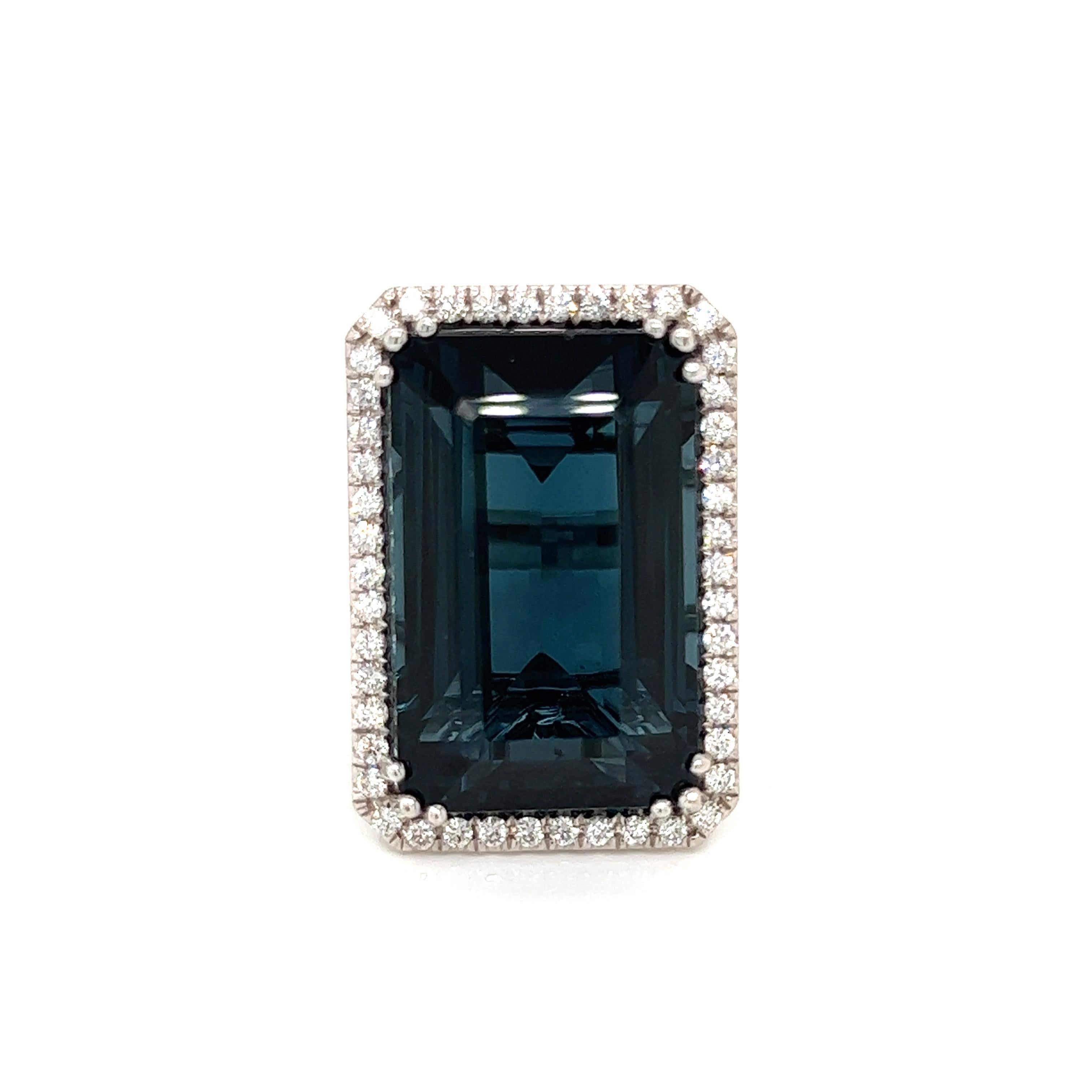 This stunning, stylish and rare emerald cut indicolite tourmaline ring will turn heads. With its unique steel blue-green, indicolite color surrounded by brilliant diamonds you will love the sophistication of this ring.  Set in 21 grams of 18K white