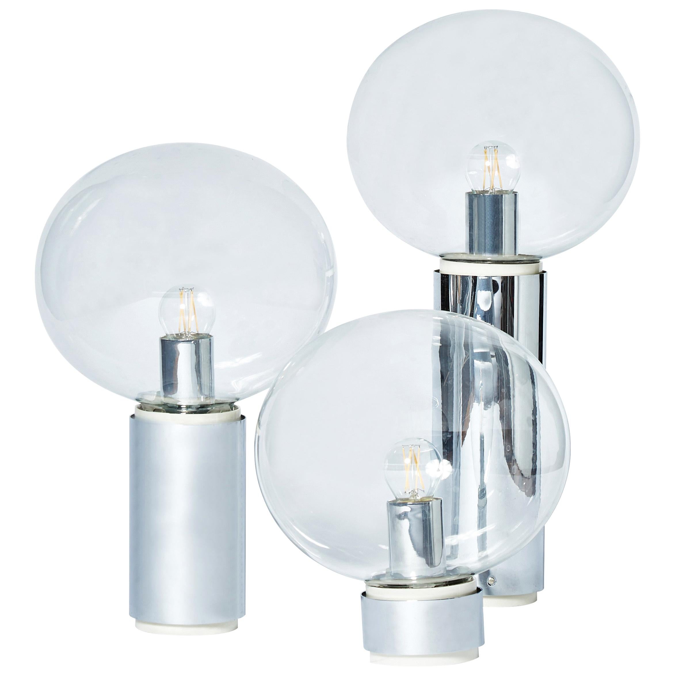 Large set of lights, used either as wall sconces or ceiling lamps, designed by the Japanese designer Motoko Ishii for the German company Staff.

Three different heights of metal tube with clear glass globes.

Each fixture is sold separately.