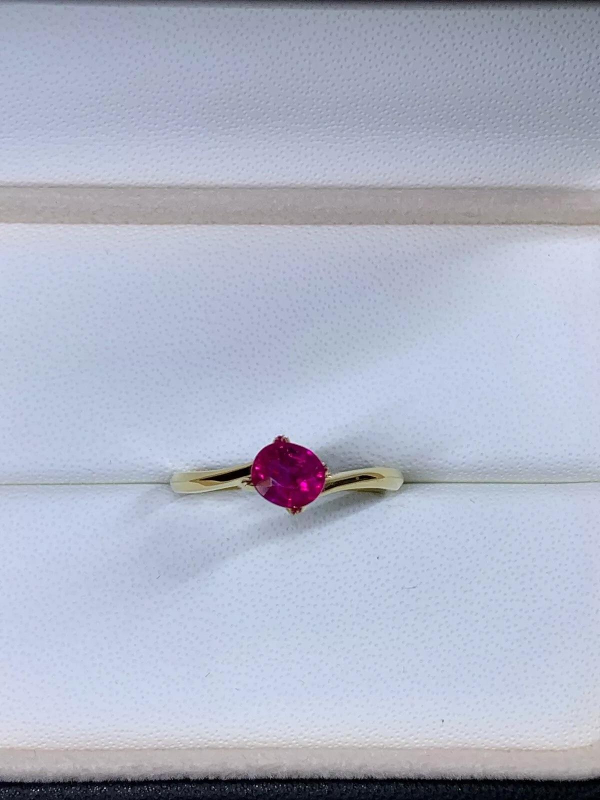 This 1.05ct Ruby Burma Solitaire Engagement Ring is a stunning piece of fine jewellery made with 18ct Yellow Gold. The captivating oval-shaped ruby stone with a natural gold colour is perfectly set in a solitaire style, making it an ideal choice as