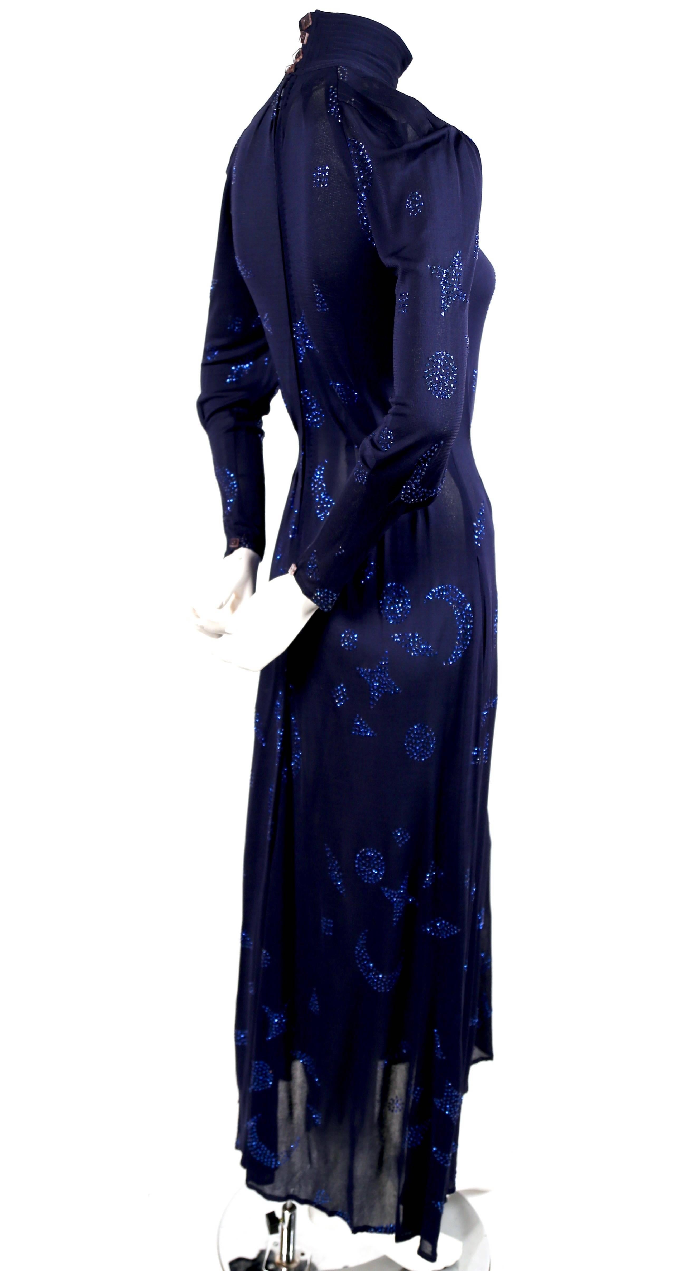 Very rare blue jersey dress with sparkling star and moon motif from Jean Muir dating to the 1970's. Dress has a very flattering cut. It is labeled a UK 8 which best fits a US 2-6. Zips up center back and secures at back of neck with four square