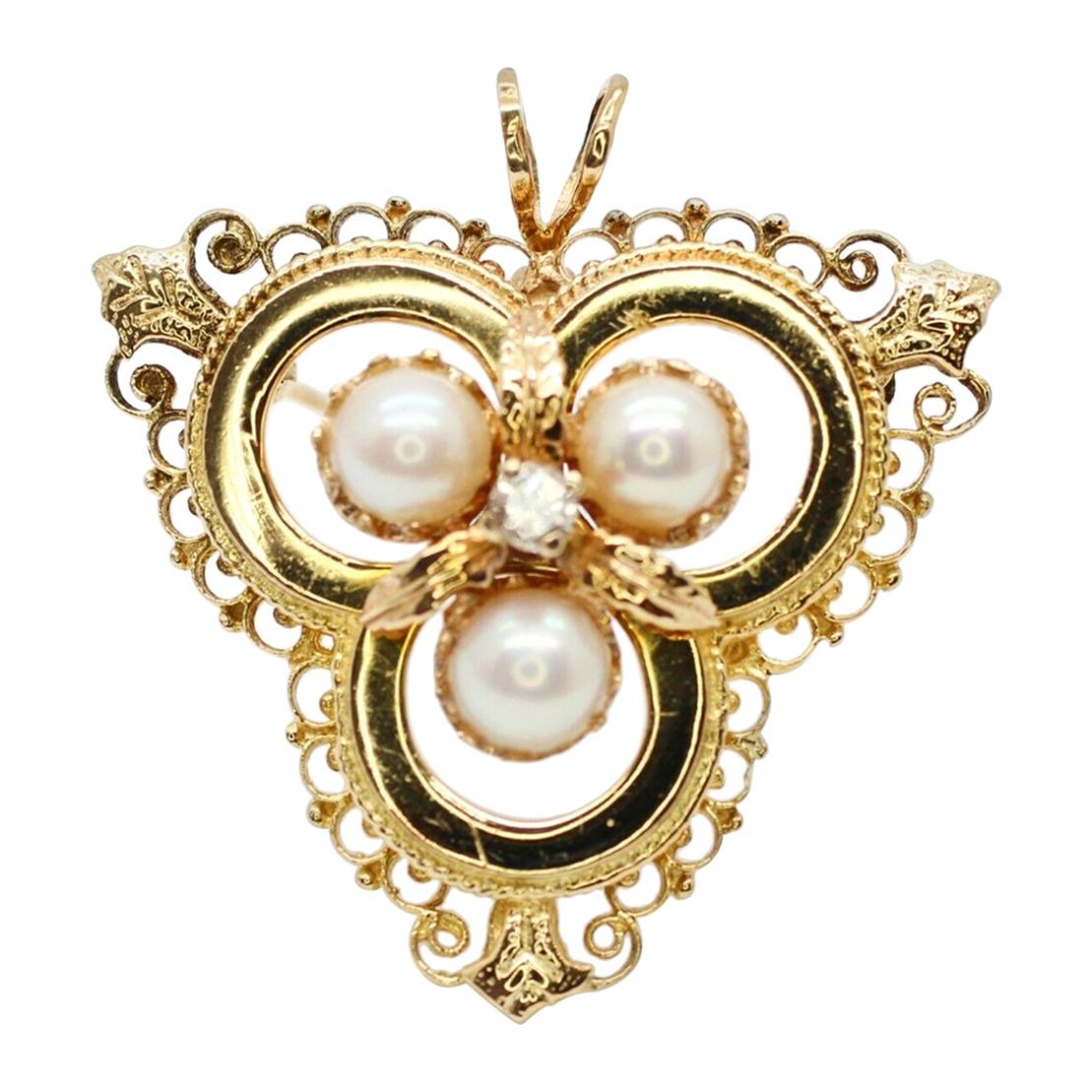 This Antique 14 Karat Yellow Gold Brooch with Pearls and Diamonds in the Center