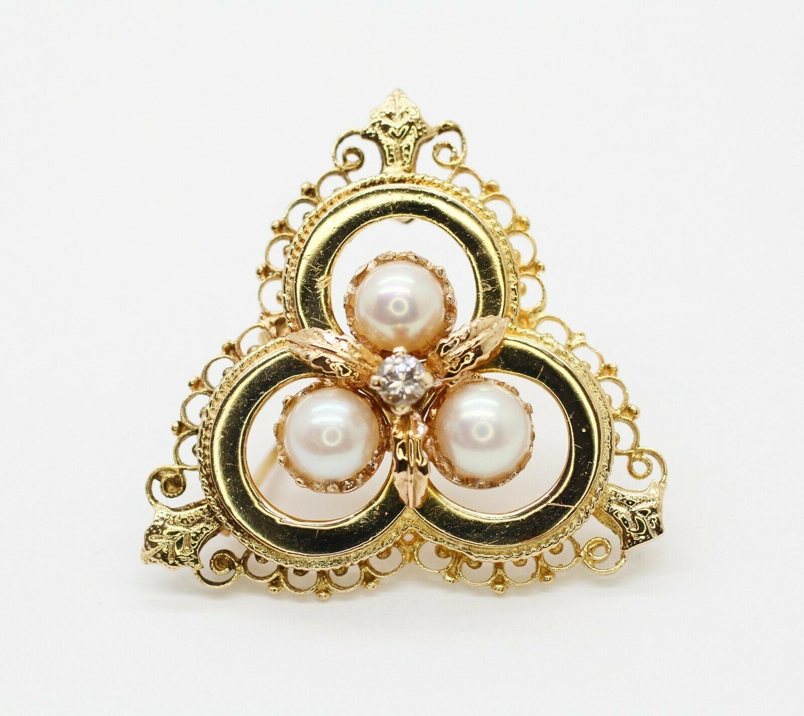    This ANTIQUE 14k yellow gold  brooch with pearls and diamonds in the center can used as pendant also.  
Specifications:
    type: BROOCH/pendant
    metal: 14K yellow gold
    CENTER STONE: 3 PIECES PEARL AND 1 DIAMOND
    LENGTH: 4 cm
   