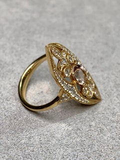 This elegant estate ring is crafted in 14K yellow gold and showcases beautiful v
