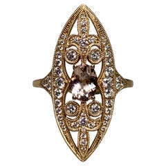 This elegant estate ring is crafted in 14K yellow gold and showcases beautiful v