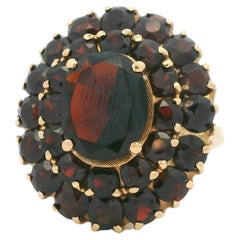This exquisite vintage Czech garnet cluster ring is crafted in 18K yellow gold a
