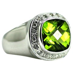 This is a 14 Karat Gold Natural Peridot with a Halo or Brilliant Round Diamonds